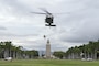 A helicopter lifting a soldier into the air.