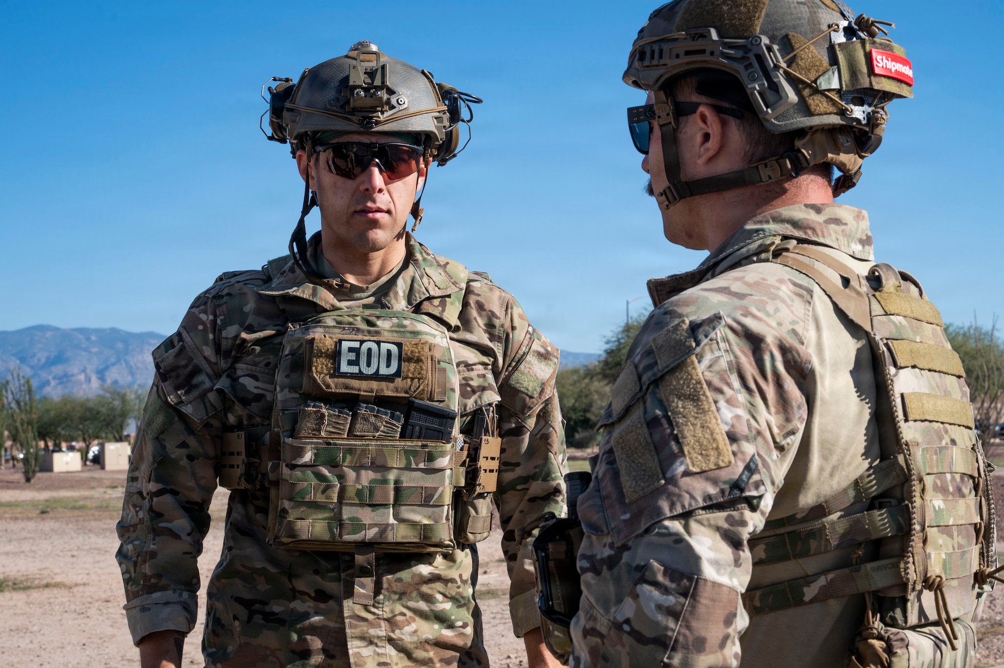 U.S. Air Force Airmen from the 355th Civil Engineer Squadron explosive ordnance disposal flight discuss possible methods to safely dispose of a simulated drone during a  scenario in part of Mosaic Lightning 26-1 at Davis-Monthan Air Force Base, Arizona, Nov. 14, 2025. The exercise required them to consider blast effects, device components and the safest disposal procedures. (U.S. Air Force photo by Airman 1st Class Samantha Melecio)