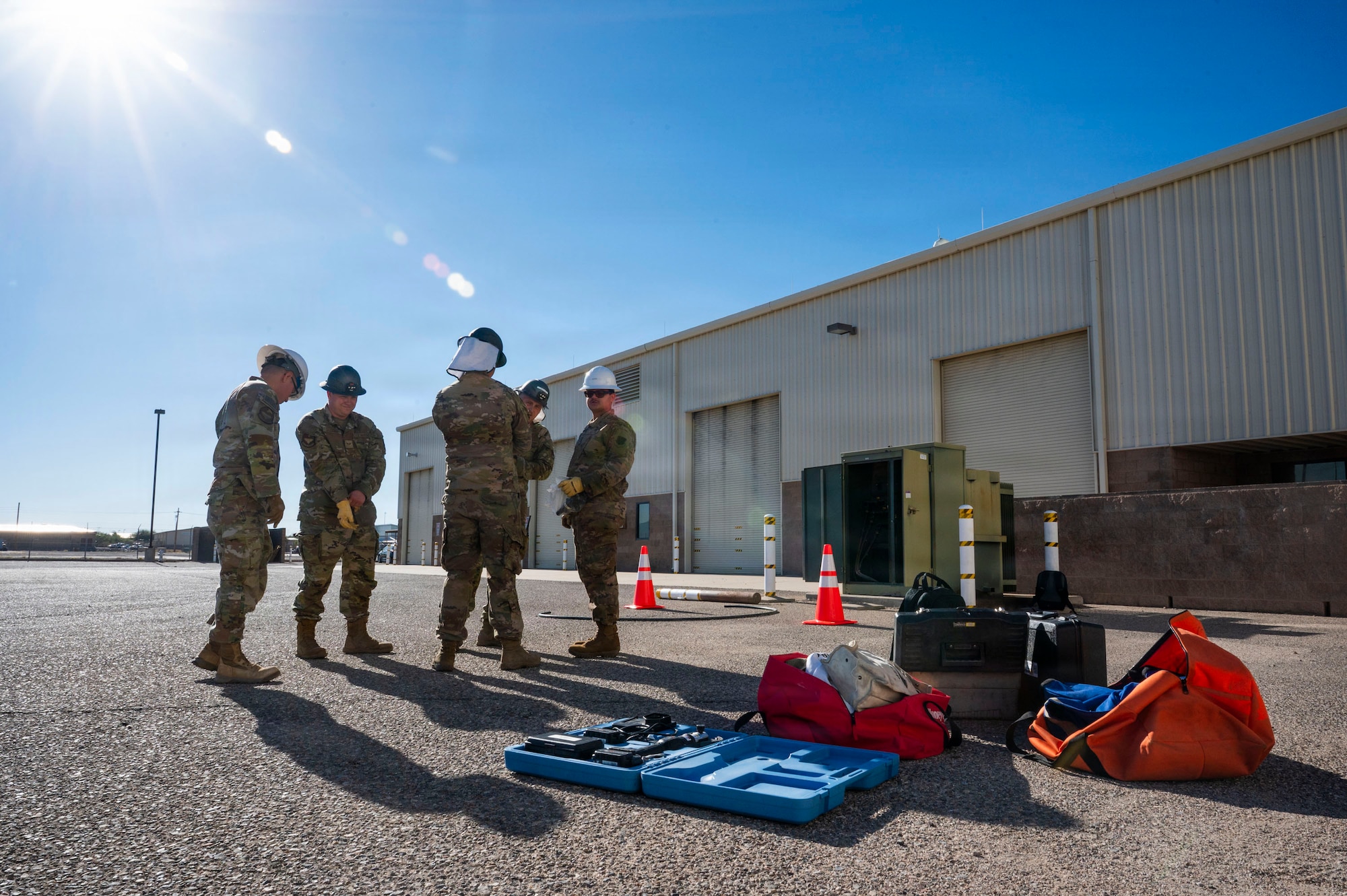 U.S. Air Force Airmen assigned to the 355th Civil Engineer squadron discuss their next steps to return power to a transformer box during Exercise Mosaic Lightning 26-1 at Davis-Monthan Air Force Base, Arizona, Nov. 12, 2025. The group of airmen went through a checklist of priorities during the exercise to ensure mission capabilities did not fail. (U.S. Air Force photo by Airman 1st Class Samantha Melecio)