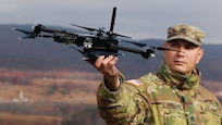 U.S. Army Staff Sgt. Luis Andujar, a Small Unmanned Aircraft Systems instructor with 1st Battalion, 166th Regiment - Regional Training Institute, Pennsylvania Army National Guard, lands a Skydio X2D SUAS during a training exercise Nov. 15, 2024 at Fort Indiantown Gap, Pa. The capabilities of the 166th Regiment RTI's 1st and 2nd Battalions melded during a unique artillery live-fire exercise, during which forward observers with 1st Battalion used several types of SUAS, including commercial off the shelf models like the Skydio X2D, to identify targets and acquire targeting data. This data was used to submit a call for fire to instructors and students with 2nd Battalion, who engaged the targets with artillery fire using M119, M777 and M109A6 howitzers. (U.S. Army National Guard photo by Sgt. 1st Class Shane Smith)