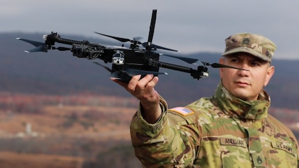 U.S. Army Staff Sgt. Luis Andujar, a Small Unmanned Aircraft Systems instructor with 1st Battalion, 166th Regiment - Regional Training Institute, Pennsylvania Army National Guard, lands a Skydio X2D SUAS during a training exercise Nov. 15, 2024 at Fort Indiantown Gap, Pa. The capabilities of the 166th Regiment RTI's 1st and 2nd Battalions melded during a unique artillery live-fire exercise, during which forward observers with 1st Battalion used several types of SUAS, including commercial off the shelf models like the Skydio X2D, to identify targets and acquire targeting data. This data was used to submit a call for fire to instructors and students with 2nd Battalion, who engaged the targets with artillery fire using M119, M777 and M109A6 howitzers. (U.S. Army National Guard photo by Sgt. 1st Class Shane Smith)