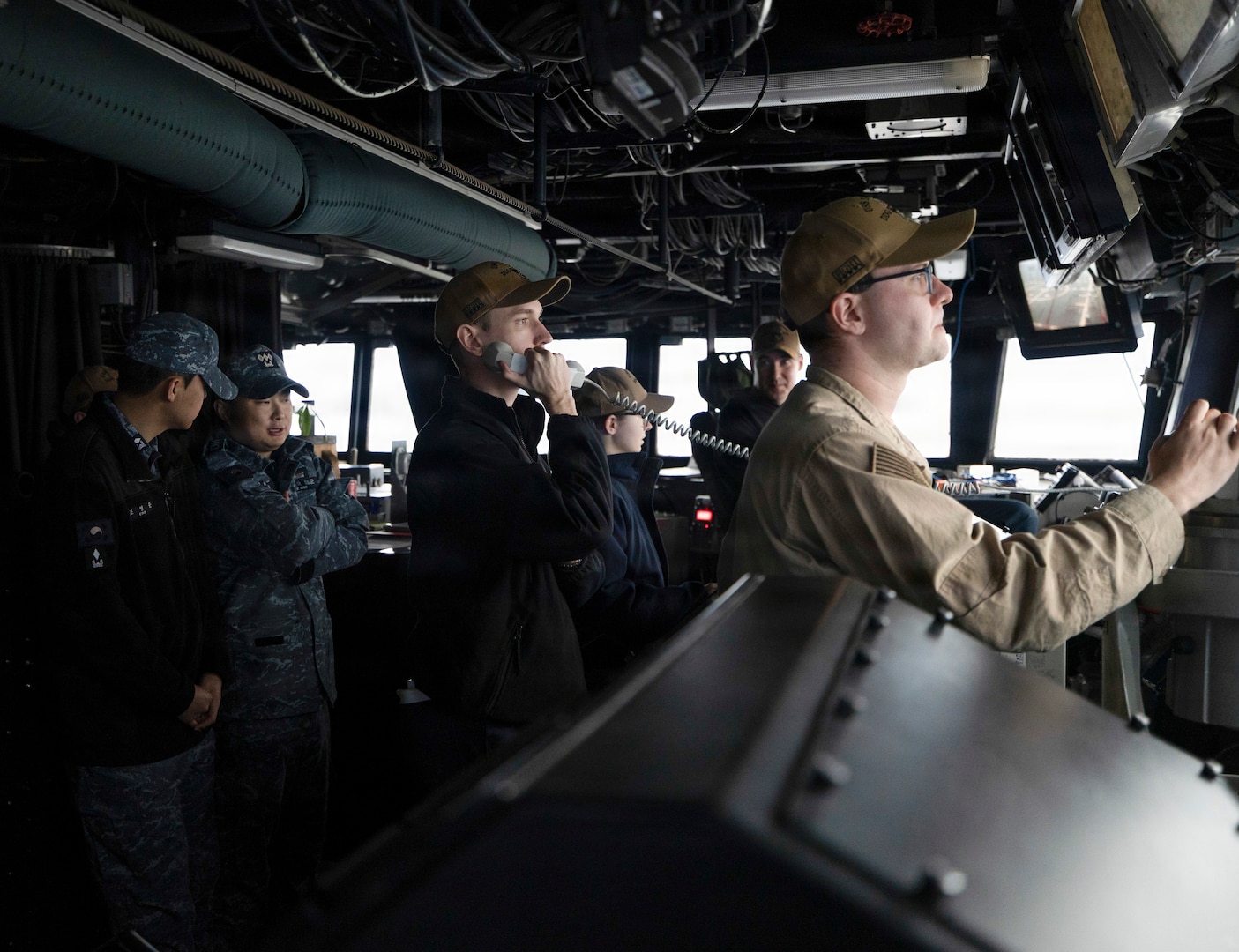 U.S. Navy Sailors and Republic of Korea (ROK) Navy Sailors collaborate on the bridge aboard Arleigh Burke-class guided-missile destroyer USS Dewey (DDG 105) during the Maritime Counter Special Operations Exercise (MCSOFEX) with the ROK Navy, Nov. 18, 2025.