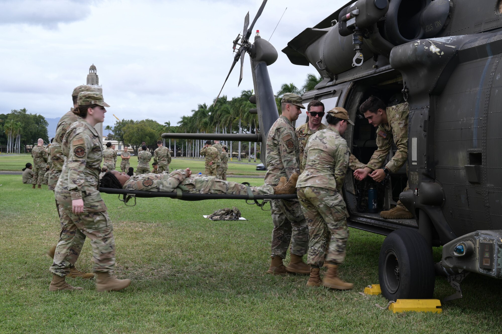 Airmen doing litter carry training into a helicopter.