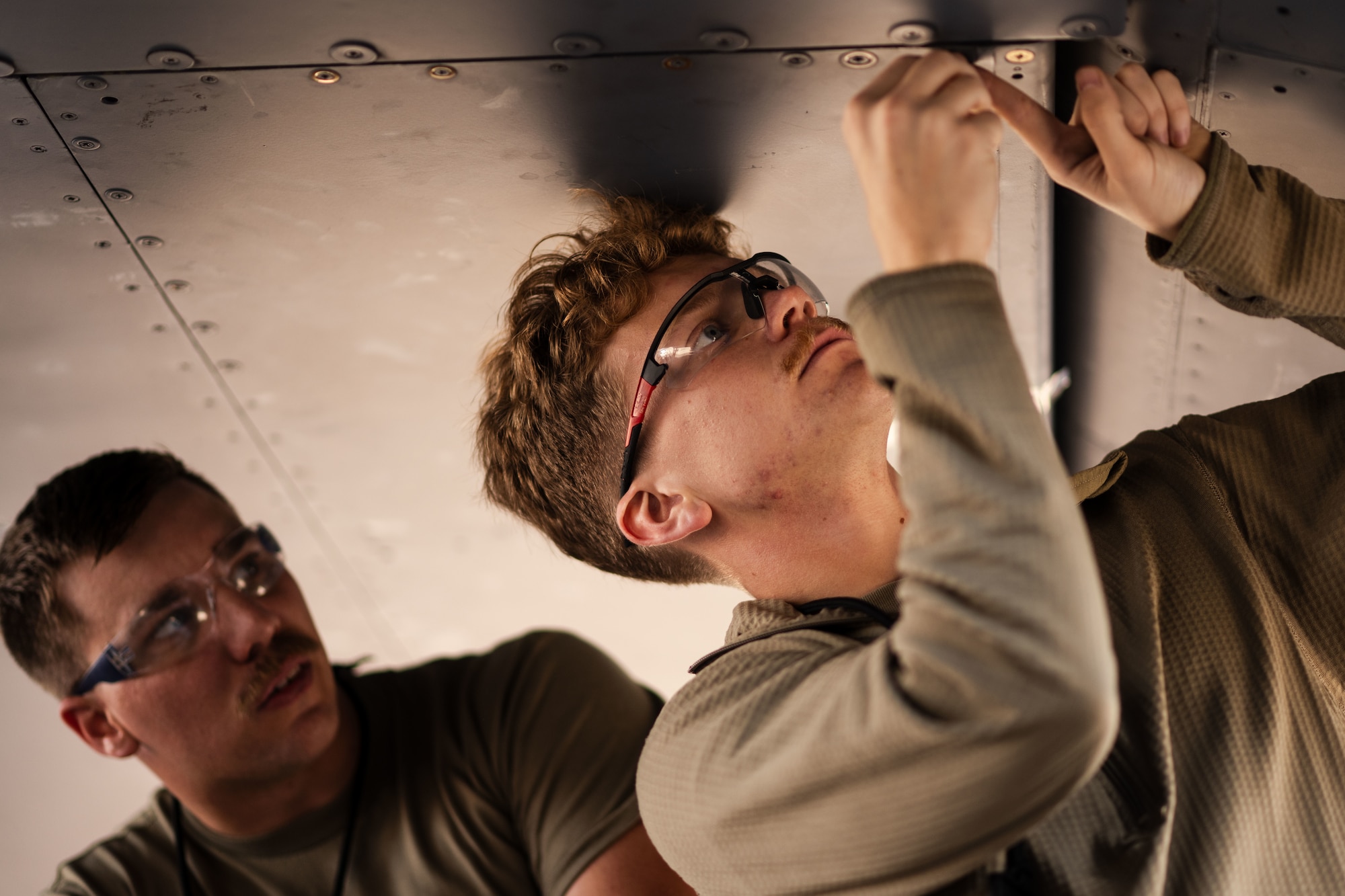 U.S. Air Force crew chiefs assigned to the 6th Aircraft Maintenance Squadron repannel a KC-135 Stratotanker following an inspection at MacDill Air Force Base, Florida, Oct. 29, 2025. Periodic inspections provide personnel with an in-depth understanding of the aircraft allowing for more accurate and effective maintenance. (U.S. Air Force photo by Senior Airman Zachary Foster)
