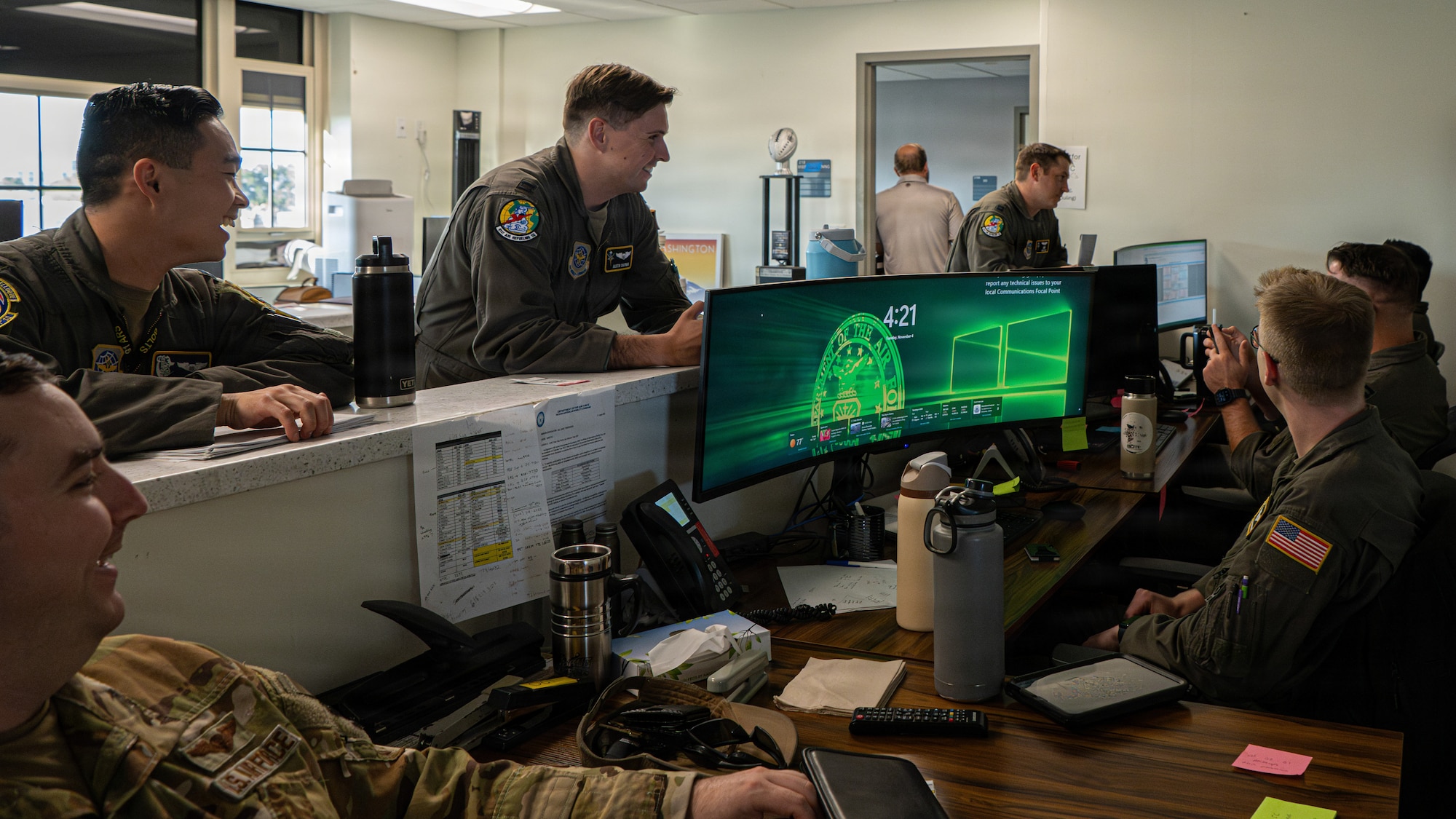Airmen assigned to the 91st Air Refueling Squadron converse with the squadron’s crew schedulers at MacDill Air Force Base, Florida, Nov. 4, 2025. When the aircrew are not flying, they are scheduling the crews needed to increase the range, lethality and versatility of combat aircraft. (U.S. Air Force photo by Airman 1st Class Helen Ly)