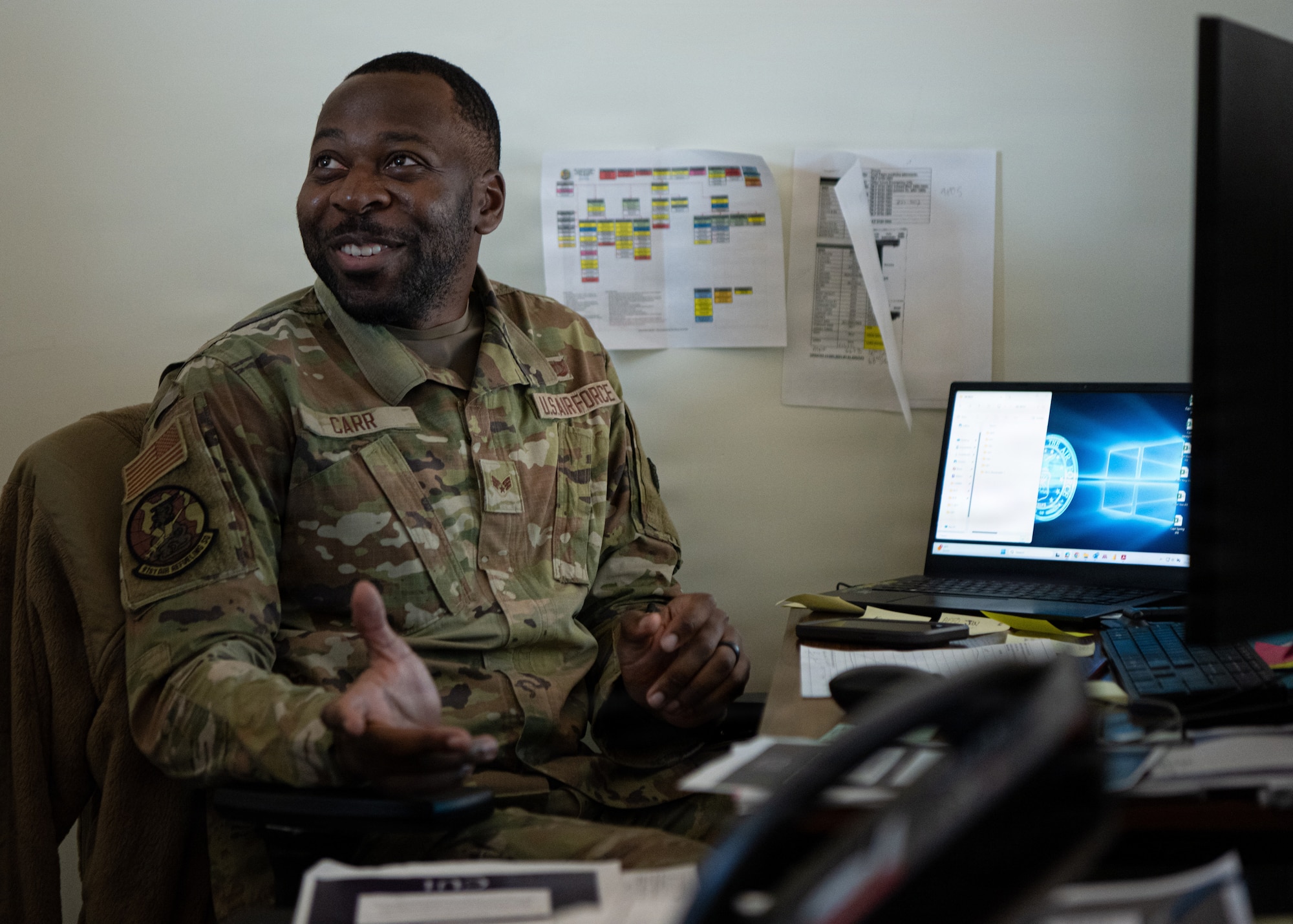 U.S. Air Force Senior Airman Lawrence Carr, 91st Air Refueling Squadron aviation resource manager, converses with aircrew members at MacDill Air Force Base, Florida, Nov. 5, 2025. Carr maintains flight records, validates aircrew safety requirements and ensures the squadron can effectively carry out the mission. (U.S. Air Force photo by Airman 1st Class Helen Ly)