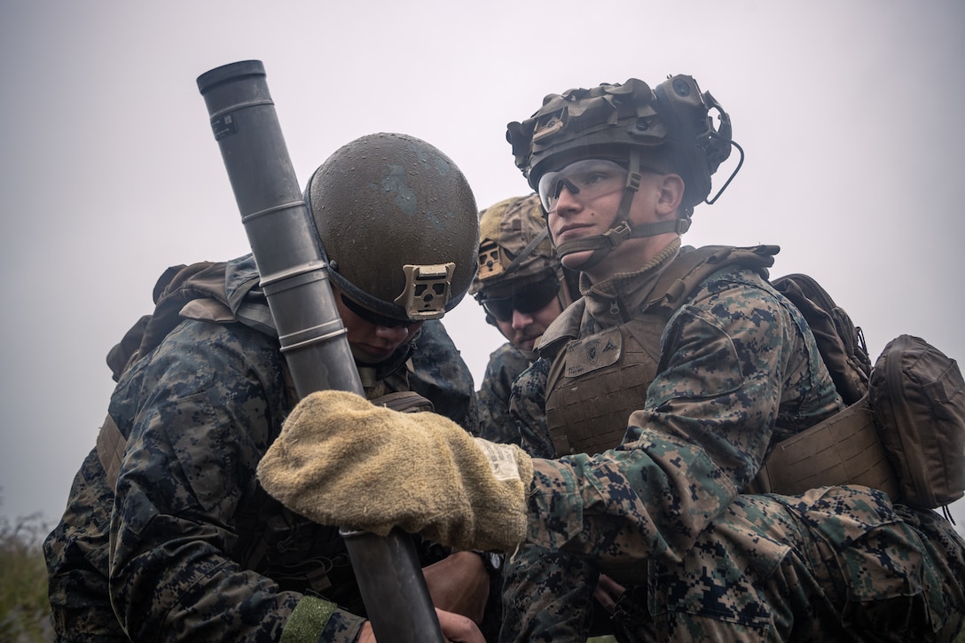 U.S. Marines with Battalion Landing Team 1st Battalion, 7th Marine Regiment, 31st Marine Expeditionary Unit, prepare to fire a 60mm mortar system during live-fire training at Combined Arms Training Center, Camp Fuji, Japan, Sept. 1, 2025. Marines conducted combined arms live-fire training to maintain operational readiness, tactical proficiency, and enhance lethality while operating within the first island chain. The 31st MEU, the Marine Corps’ only continuously forward-deployed MEU, provides a flexible and lethal force ready to perform a wide range of military operations as the premiere crisis response force in the Indo-Pacific region. (U.S. Marine Corps photo by Lance Cpl. Victor Gurrola)