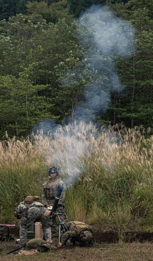 U.S. Marines with Weapons Company, Battalion Landing Team 1st Battalion, 7th Marine Regiment, 31st Marine Expeditionary Unit, fire an M252A2 81mm mortar system during live-fire training at Combined Arms Training Center, Camp Fuji, Japan, Sept. 30, 2025. Marines conducted combined arms live-fire training to maintain operational readiness, tactical proficiency, and enhance lethality while operating within the first island chain. The 31st MEU, the Marine Corps’ only continuously forward-deployed MEU, provides a flexible and lethal force ready to perform a wide range of military operations as the premiere crisis response force in the Indo-Pacific region. (U.S. Marine Corps photo by Lance Cpl. Victor Gurrola)