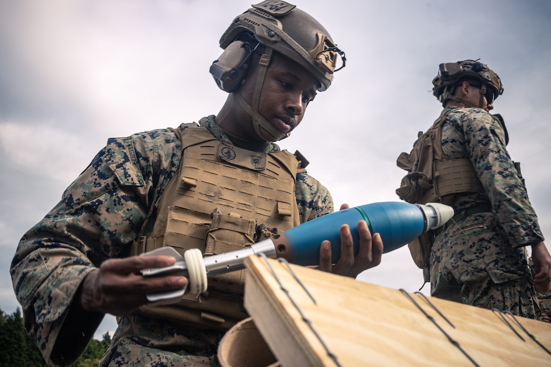 U.S. Marine Corps Lance Cpl. Kevin Benson, a mortarman with Weapons Company, Battalion Landing Team 1st Battalion, 7th Marine Regiment, 31st Marine Expeditionary Unit, prepares an 81mm mortar round during live-fire training at Combined Arms Training Center, Camp Fuji, Japan, Sept. 30, 2025. Marines conducted combined arms live-fire training to maintain operational readiness, tactical proficiency, and enhance lethality while operating within the first island chain. The 31st MEU, the Marine Corps’ only continuously forward-deployed MEU, provides a flexible and lethal force ready to perform a wide range of military operations as the premiere crisis response force in the Indo-Pacific region. Benson is a native of Maryland. (U.S. Marine Corps photo by Lance Cpl. Victor Gurrola)