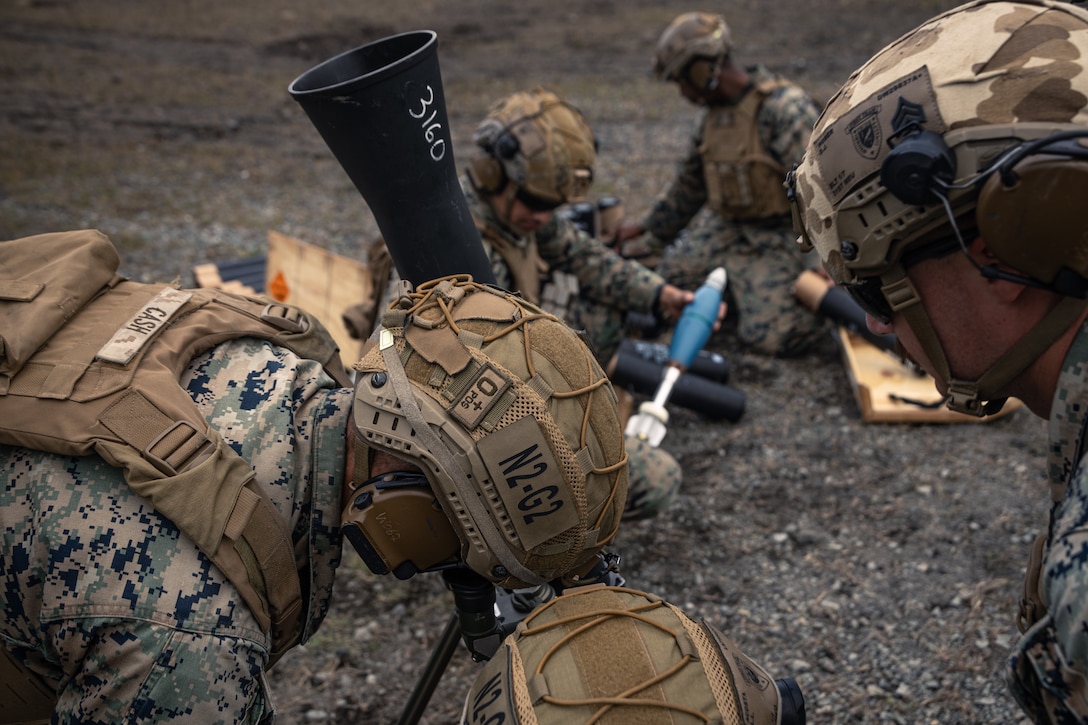U.S. Marines with Weapons Company, Battalion Landing Team 1st Battalion, 7th Marine Regiment, 31st Marine Expeditionary Unit, prepare an 81mm mortar system during live-fire training at Combined Arms Training Center, Camp Fuji, Japan, Sept. 30, 2025. Marines conducted combined arms live-fire training to maintain operational readiness, tactical proficiency, and enhance lethality while operating within the first island chain. The 31st MEU, the Marine Corps’ only continuously forward-deployed MEU, provides a flexible and lethal force ready to perform a wide range of military operations as the premiere crisis response force in the Indo-Pacific region. (U.S. Marine Corps photo by Lance Cpl. Victor Gurrola)