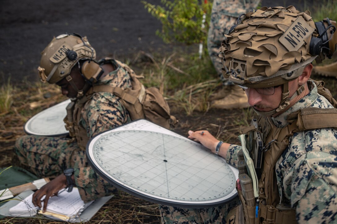 U.S. Marines with Weapons Company, Battalion Landing Team 1st Battalion, 7th Marine Regiment, 31st Marine Expeditionary Unit, plot grids during live-fire training at Combined Arms Training Center, Camp Fuji, Japan, Sept. 30, 2025. Marines conducted combined arms live-fire training to maintain operational readiness, tactical proficiency, and enhance lethality while operating within the first island chain. The 31st MEU, the Marine Corps’ only continuously forward-deployed MEU, provides a flexible and lethal force ready to perform a wide range of military operations as the premiere crisis response force in the Indo-Pacific region. (U.S. Marine Corps photo by Lance Cpl. Victor Gurrola)