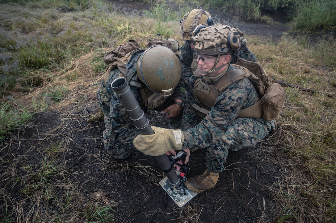 U.S. Marines with Battalion Landing Team 1st Battalion, 7th Marine Regiment, 31st Marine Expeditionary Unit, prepare to fire a 60mm mortar system during live-fire training at Combined Arms Training Center, Camp Fuji, Japan, Oct. 1, 2025. Marines conducted combined arms live-fire training to maintain operational readiness, tactical proficiency, and enhance lethality while operating within the first island chain. The 31st MEU, the Marine Corps’ only continuously forward-deployed MEU, provides a flexible and lethal force ready to perform a wide range of military operations as the premiere crisis response force in the Indo-Pacific region. (U.S. Marine Corps photo by Lance Cpl. Victor Gurrola)
