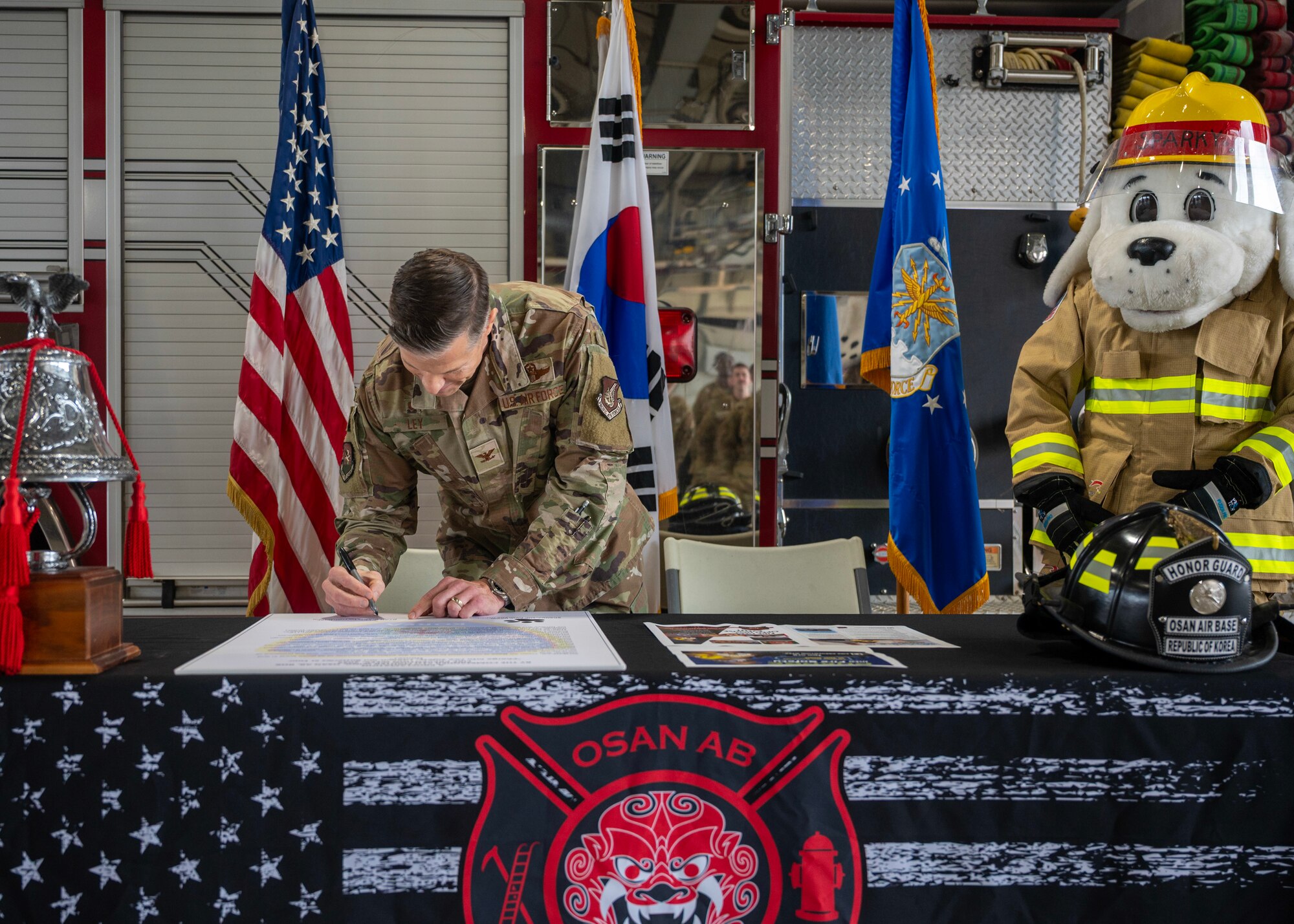 U.S. Air Force Col. Ryan Ley, 51st Fighter Wing commander, signs a proclamation to kickstart Fire Prevention Week at Osan Air Base, Republic of Korea, Oct. 6, 2025. Fire Prevention Week focuses on providing the knowledge and tools to react quickly during a fire emergency. (U.S. Air Force photos by Staff Sgt. Sarah Williams)