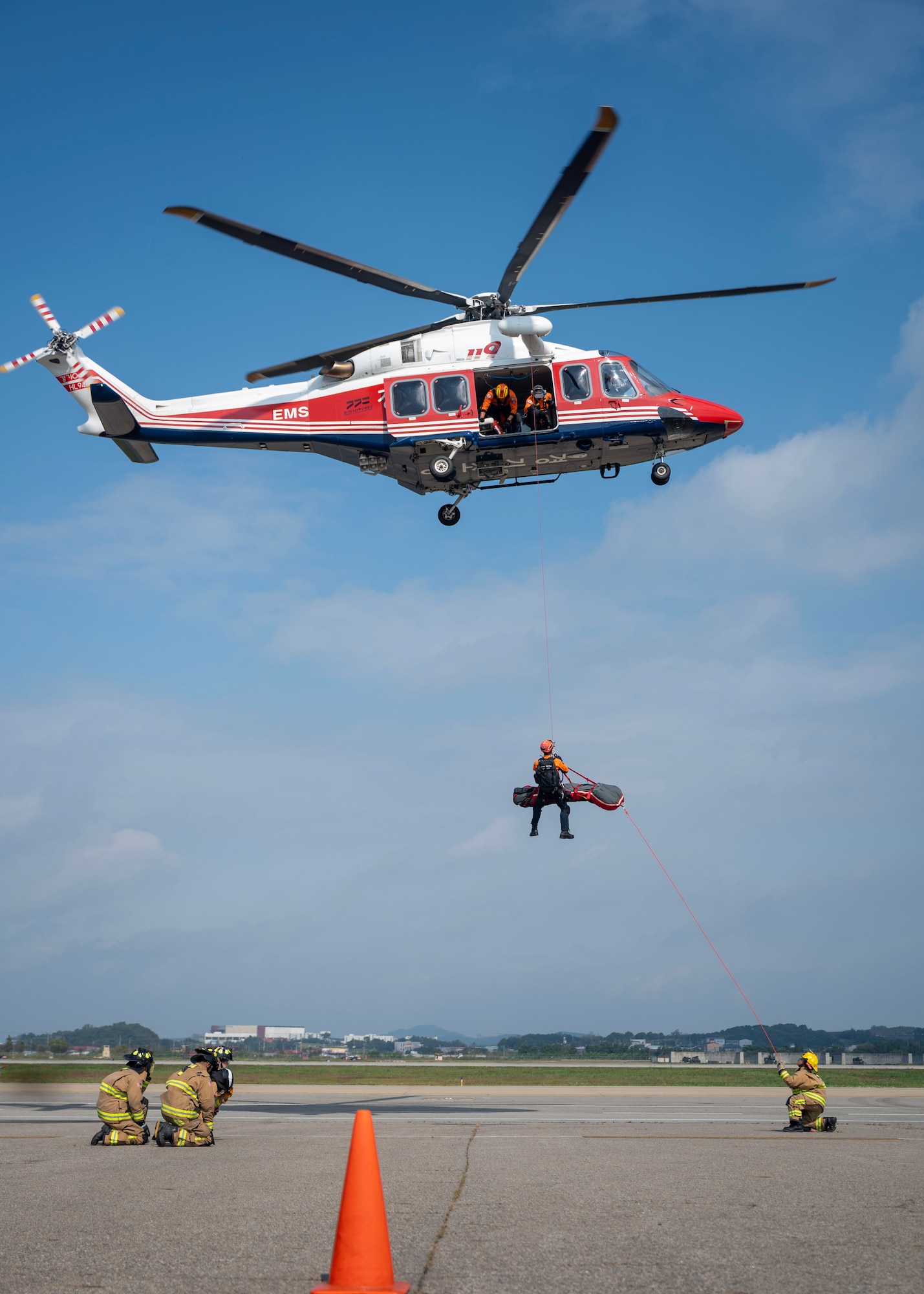 U.S. Air Force and Gyeonggi-do Special Rescue Service work together to perform an emergency air medical evacuation demonstration at an open house event during Fire Prevention Week at Osan Air Base, Republic of Korea, Oct. 11, 2025. Joint medevac training builds mutual understanding of procedures, terminology and technology so both air forces can operate seamlessly during real-world emergencies. (U.S. Air Force photos by Staff Sgt. Sarah Williams)