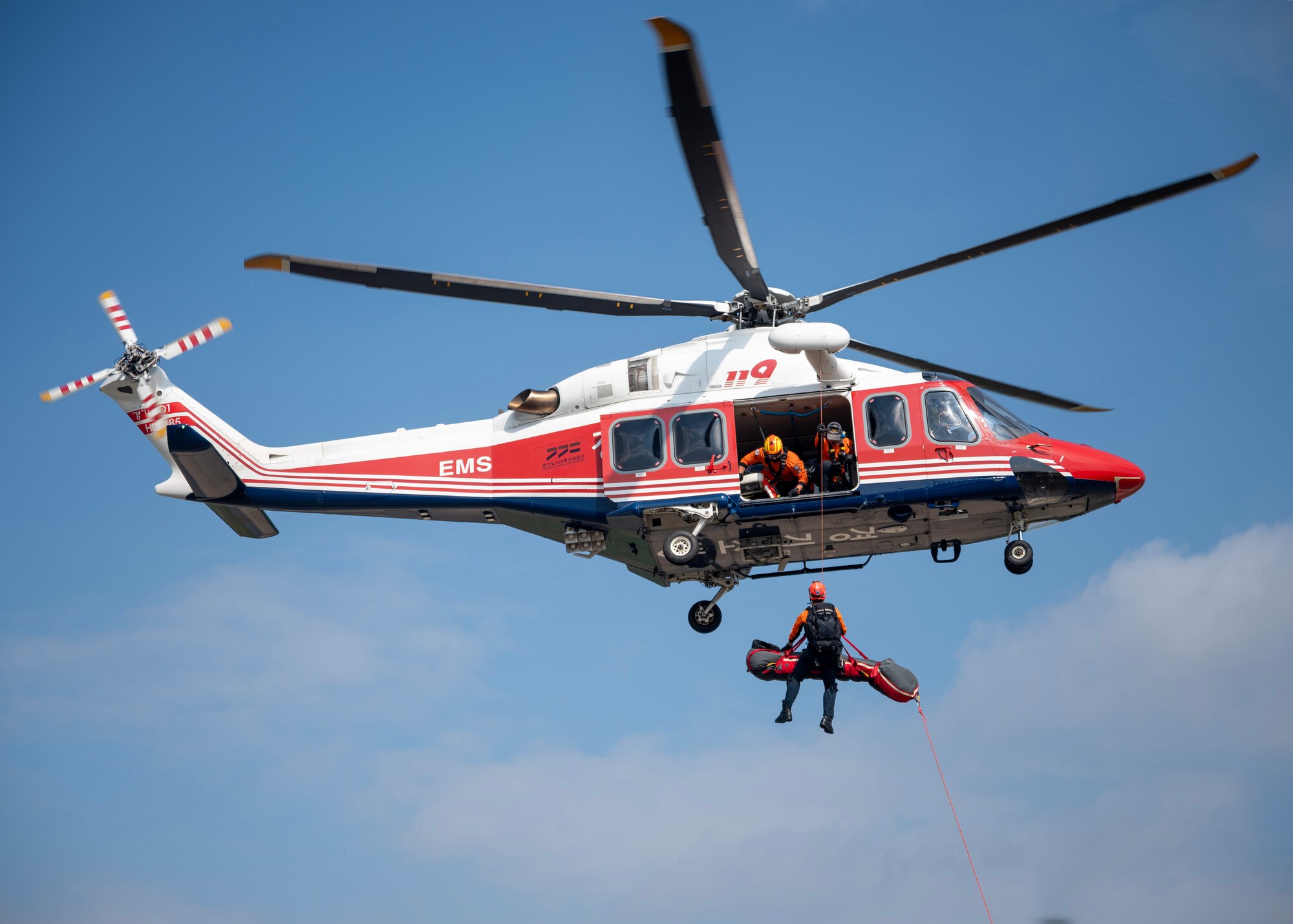 Gyeonggi-do Special Rescue Service performs an emergency air medical evacuation demonstration at an open house event during Fire Prevention Week at Osan Air Base, Republic of Korea, Oct. 11, 2025. Medical evacuations ensure that military members receive immediate and advanced care, giving them the best possible chance of survival and recovery. (U.S. Air Force photos by Staff Sgt. Sarah Williams)