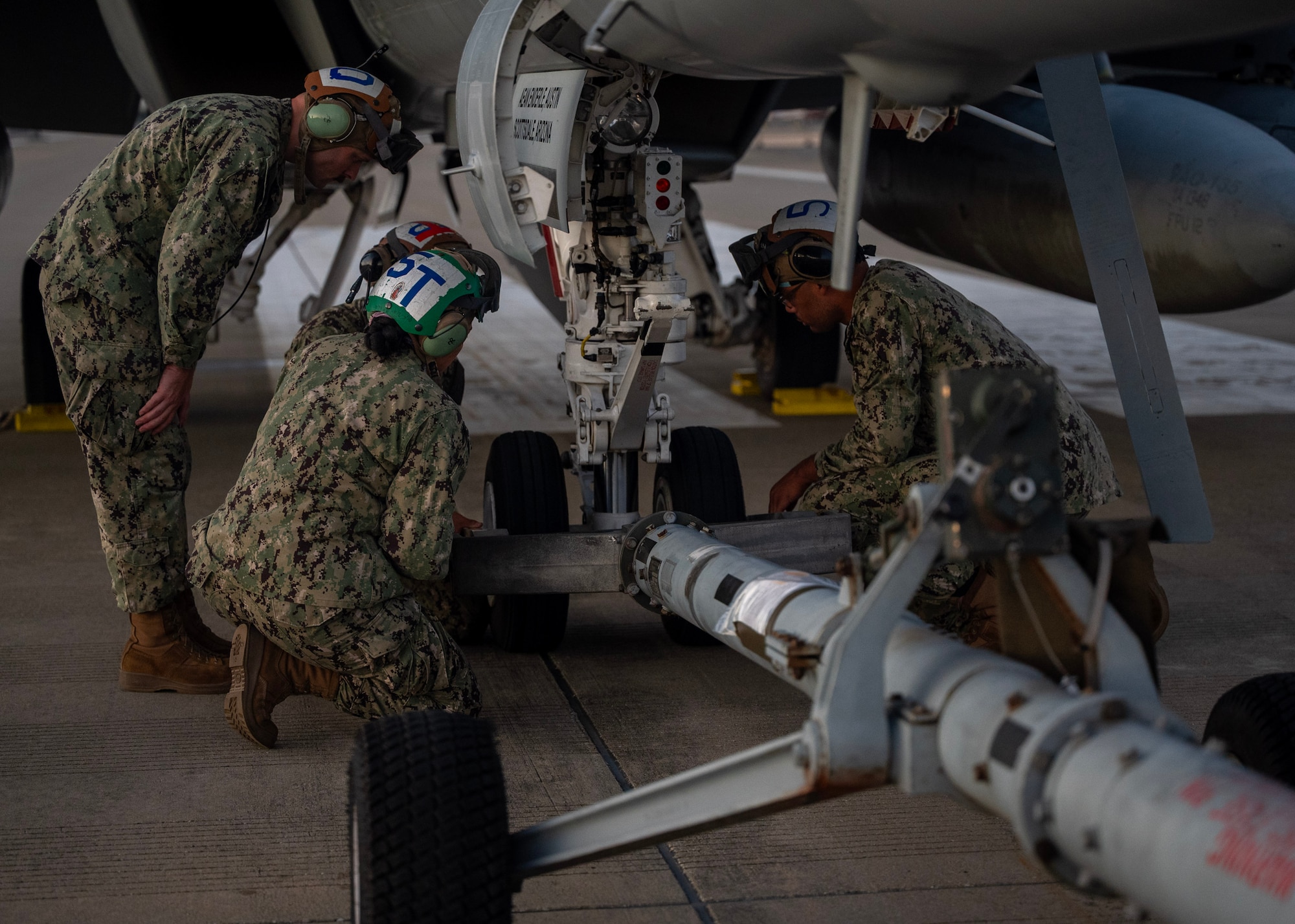 U.S. Navy service members from the Electronic Attack Squadron (VAQ) 135 Black Ravens, attach a tow to an EA-18 Growler at Seoul Air Base, Republic of Korea, Oct. 16, 2025. The 2025 Seoul International Aerospace and Defense Exhibition strengthened the U.S.-ROK alliance and regional security through cooperation, dialogue, and shared innovation. (U.S. Air Force photo by Staff Sgt. Sarah Williams)