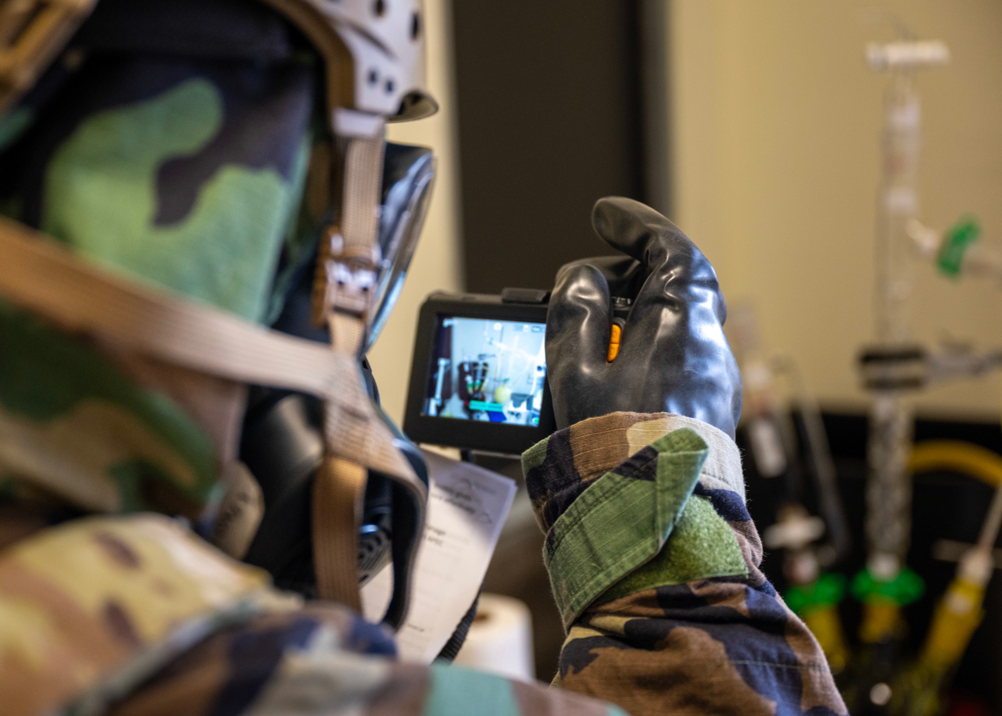 A 51st Civil Engineer Squadron Airman takes a  photo during a chemical, biological, radiological and nuclear exercise at Osan Air Base, Republic of Korea, Oct. 30, 2025. Members practiced site surveys, sampling and unexploded ordnance protocols to enhance readiness for future contingencies. (U.S. Air Force photo by Staff Sgt. Sarah Williams)