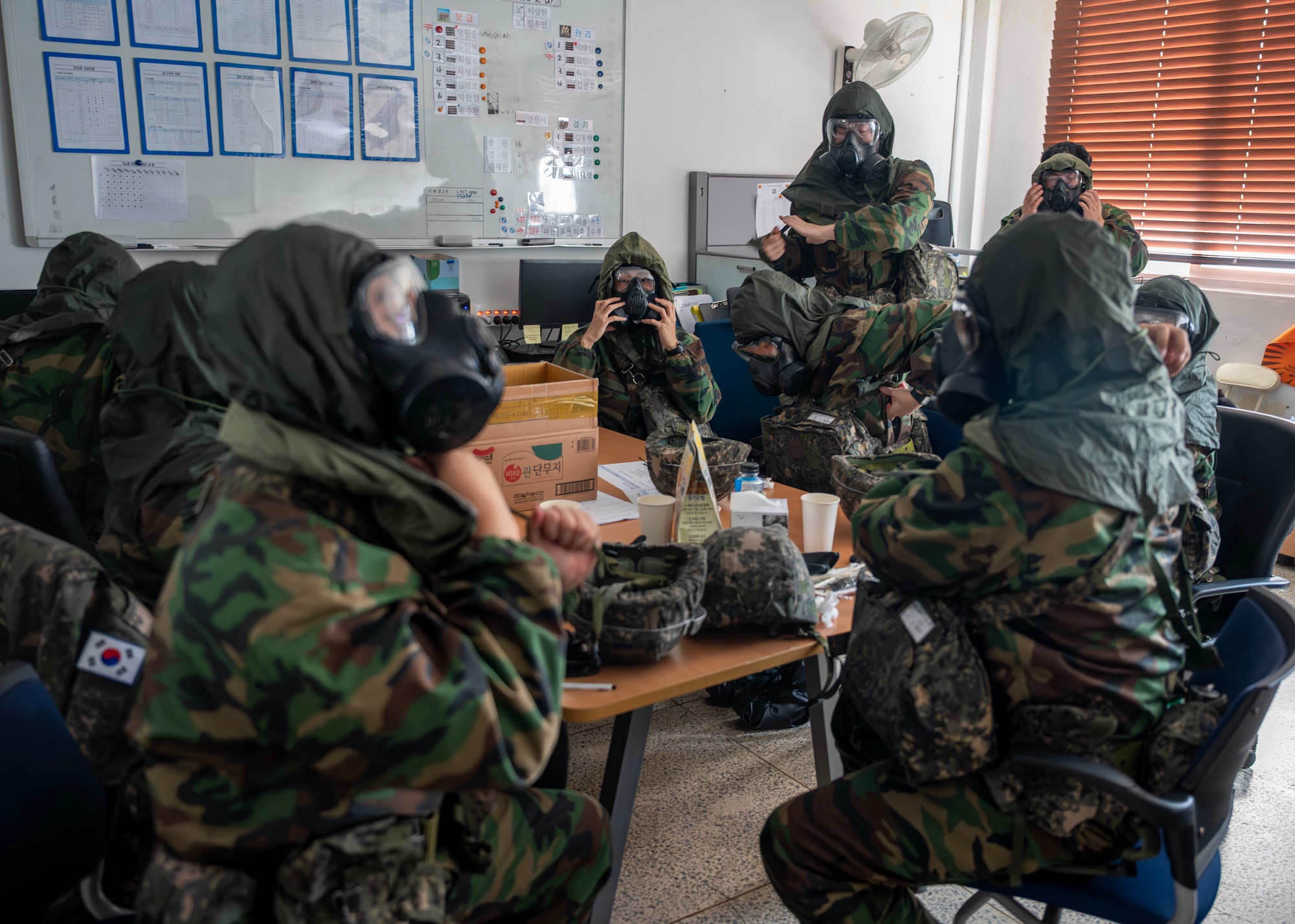 Members of the Republic of Korea Air Force  don chemical, biological, radiological, and nuclear gear during a CBRN response exercise at Osan Air Base, ROK, Oct. 30, 2025. The bilateral training emphasized equipment interoperability, mask-on response times and decontamination procedures. (U.S. Air Force photo by Staff Sgt. Sarah Williams)