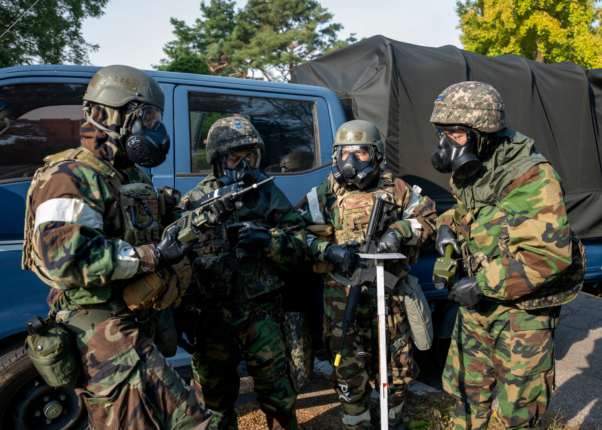 Members of 51st Civil Engineer Squadron and Republic of Korea Air Force inspect M8 chemical detection paper during a chemical, biological, radiological and nuclear response exercise at Osan Air Base, ROK, Oct. 30, 2025. Through realistic scenarios, service members identified operational gaps and developed new solutions to strengthen CBRN readiness. (U.S. Air Force photo by Staff Sgt. Sarah Williams)