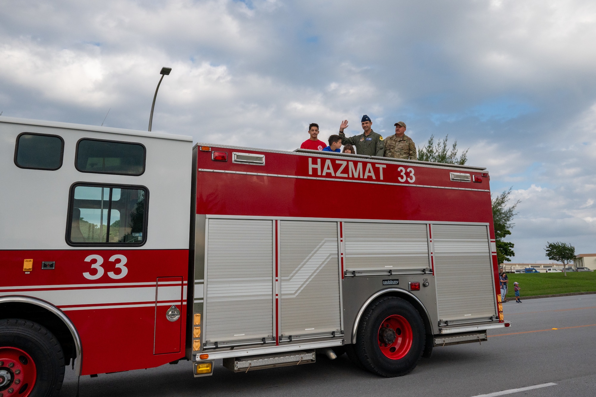 military members wave during parade