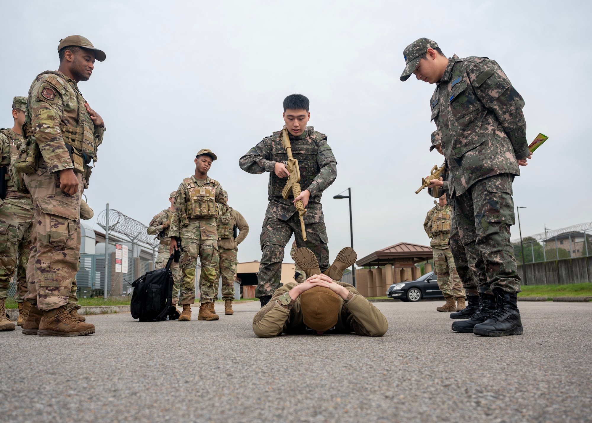 Republic of Korea Air Force Lt. Nam Kang Hee, ROKAF military police, practices enemy prisoner of war detainment procedures during a Combat Readiness Course at Osan Air Base, ROK, Oct. 21, 2025. The training focused on how to safely search, secure, and control enemy personnel during base-defense operations ensuring proper tactical and legal protocols. (U.S. Air Force photo by Staff Sgt. Sarah Williams)