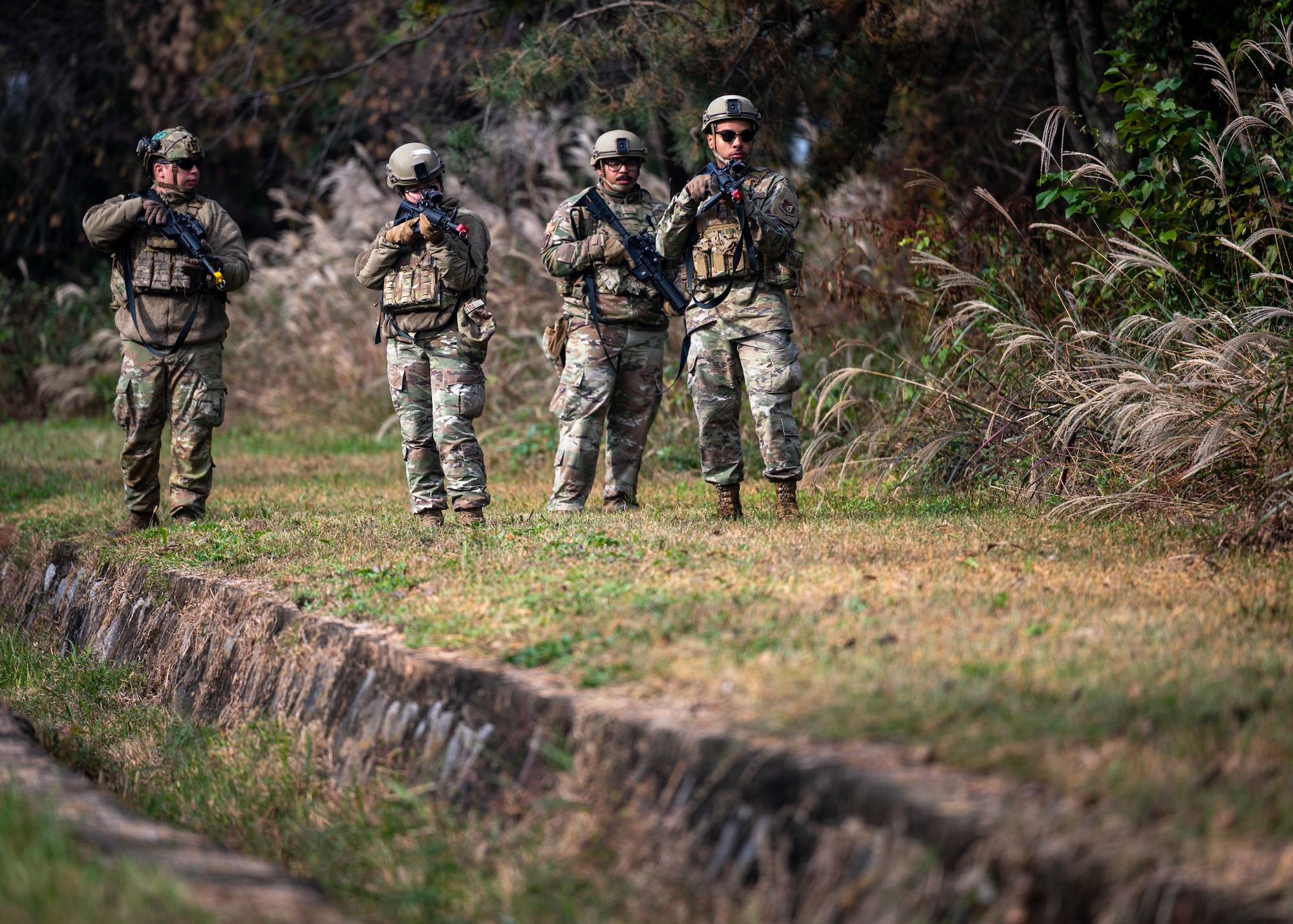 Members of the 51st Security Forces Squadron perform dismounted procedures at Osan Air Base, Republic of Korea, Oct. 29, 2025. Combat Readiness Course strengthened Osan’s defense posture by ensuring Airmen can react quickly, communicate clearly, and operate confidently during crisis situations. (U.S. Air Force photo by Staff Sgt. Sarah Williams)