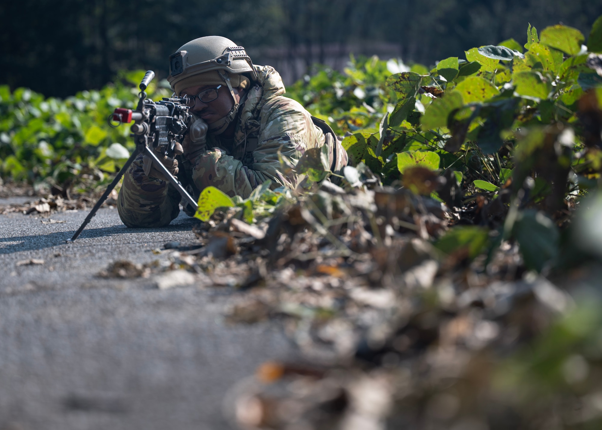 U.S. Air Force Airman 1st Class Javien Bennet, 51st Security Squadron defender, stands guard during a Combat Readiness Course at Osan Air Base, Republic of Korea, Oct. 29, 2025. CRC is a 10-day course which incorporates mounted and dismounted operations, tactical combat casualty care, and buddy drags to better prepare Airmen to defend the base under realistic combat and ground-threat scenarios. (U.S. Air Force photo by Staff Sgt. Sarah Williams)