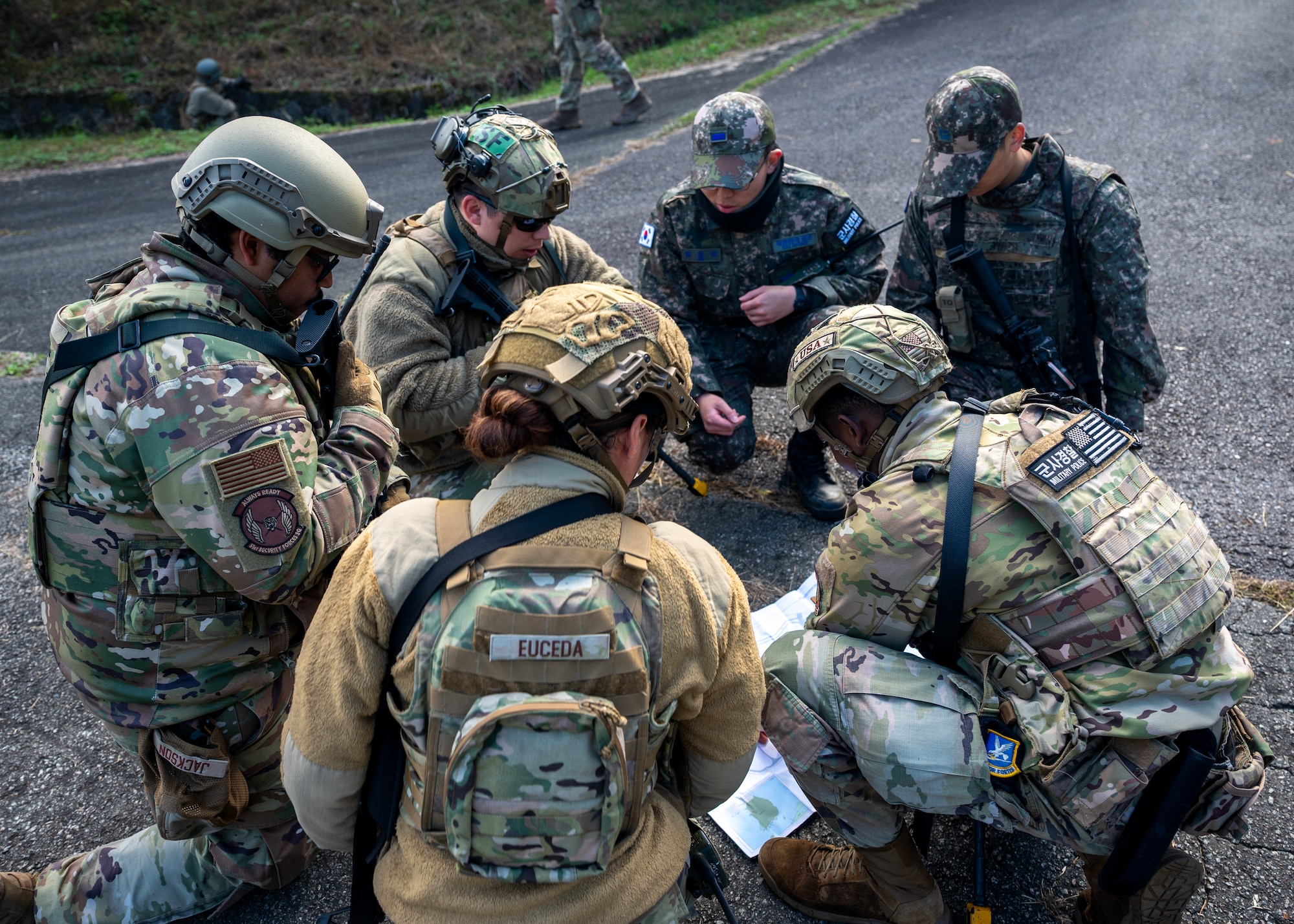 Members of 51st Security Squadron and Republic of Korea Air Force come up with a plan at Osan Air Base, ROK, Oct. 29, 2025. The involvement of ROKAF added a critical joint-training experience, ensuring both forces can respond seamlessly during real-world contingencies. (U.S. Air Force photo by Staff Sgt. Sarah Williams)