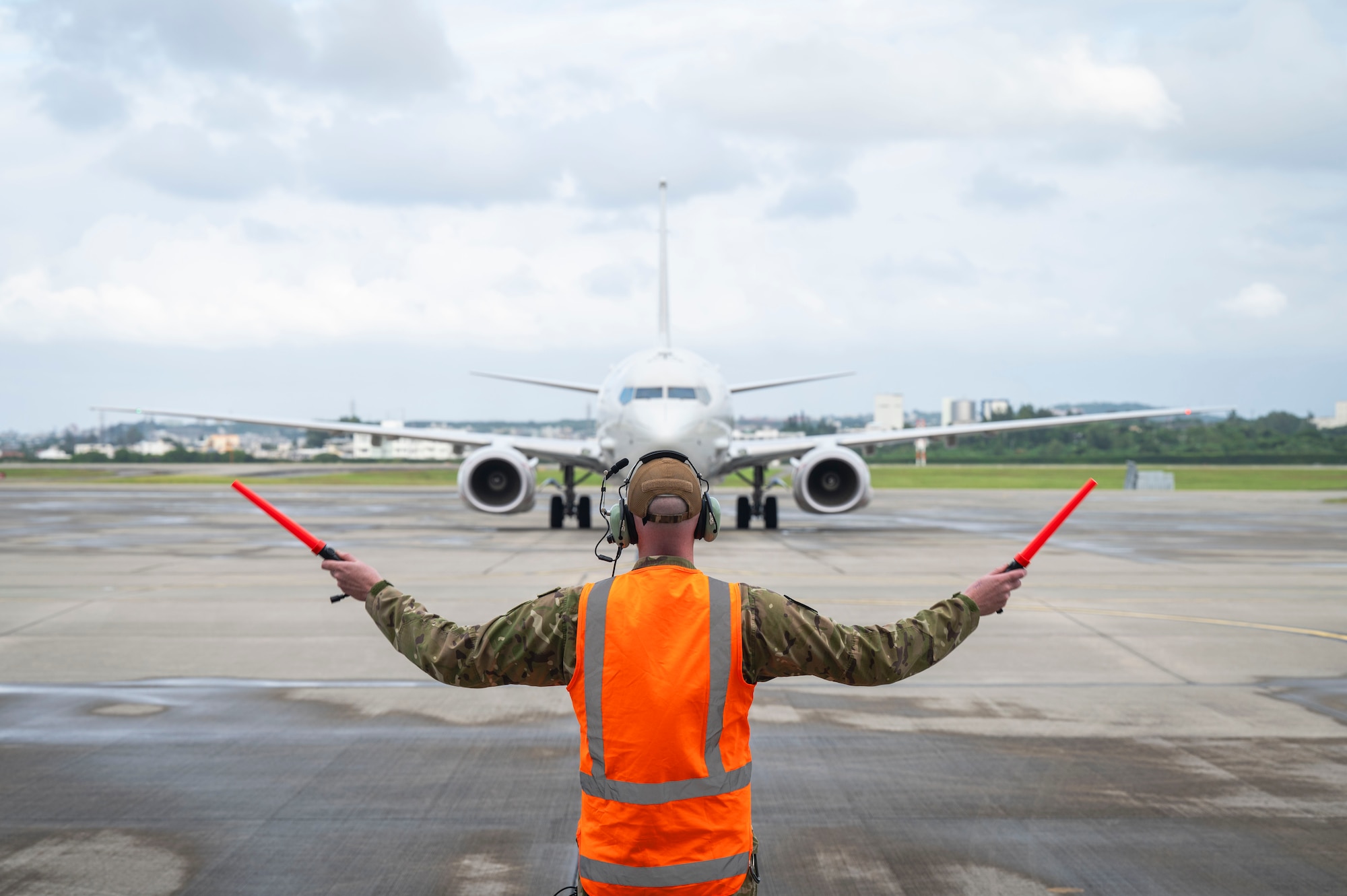 Royal New Zealand Air Force Sgt. Scott Legg, No. 5 Squadron aircraft technician, marshals a RNZAF P-8A Poseidon at Kadena Air Base, Japan, Nov. 14, 2025.