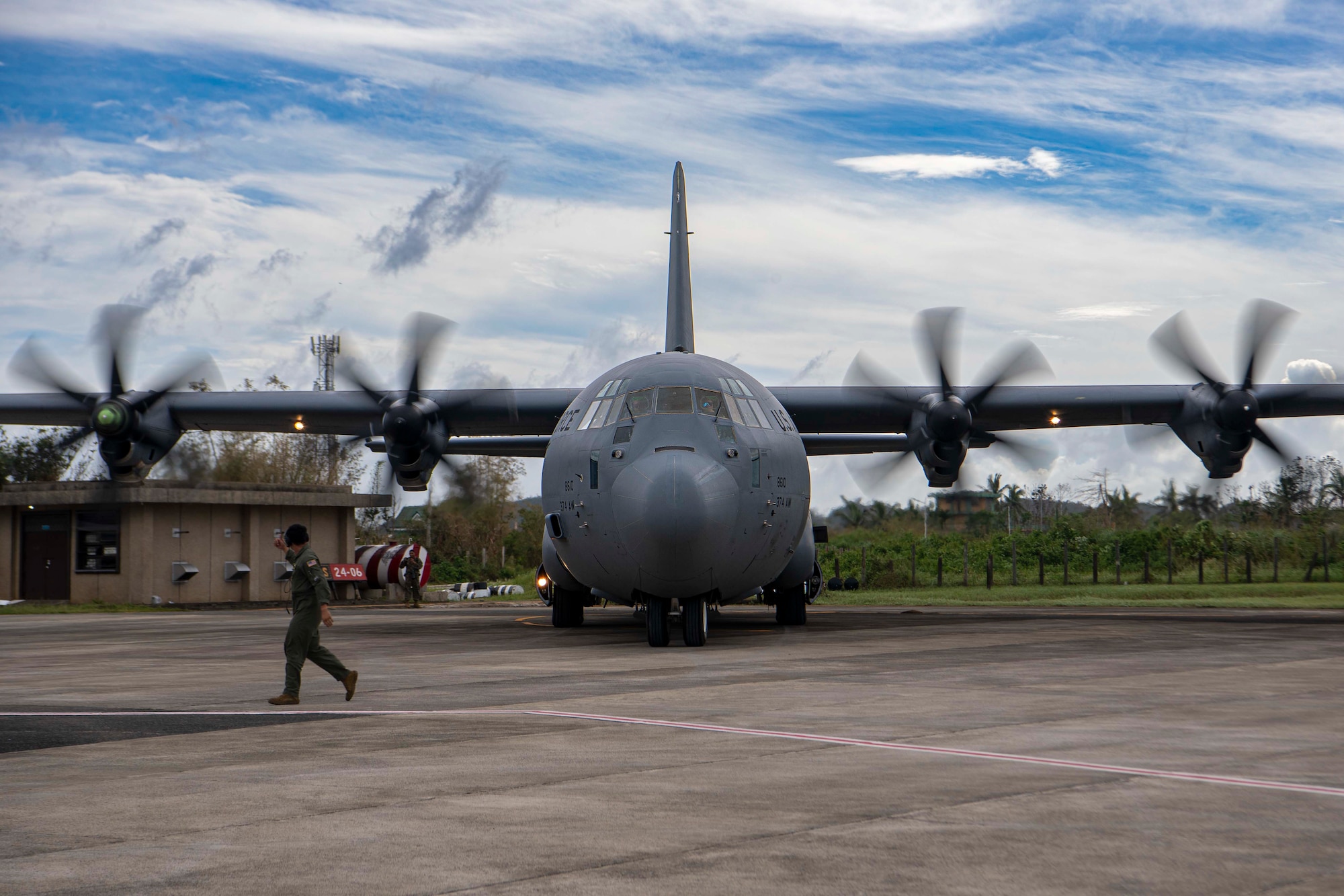 A U.S. Air Force C-130J Super Hercules assigned to the 36th Airlift Squadron prepares to conduct an engine-running offload of palletized family food packs during a foreign disaster relief operation.