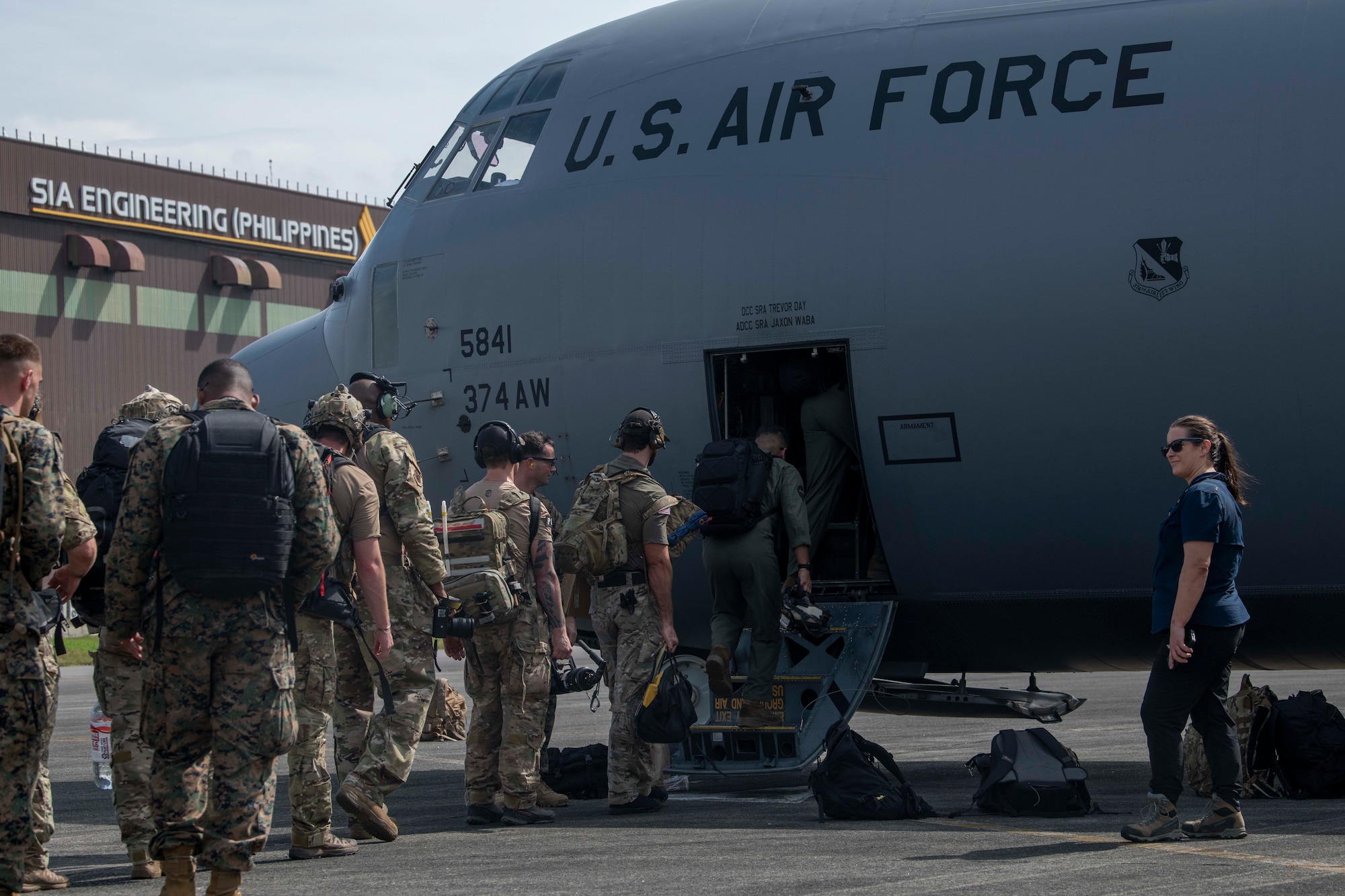 U.S. Air Force Airmen and U.S. Marines board a C-130J Super Hercules assigned to the 36th Airlift Squadron during a foreign disaster relief operation.