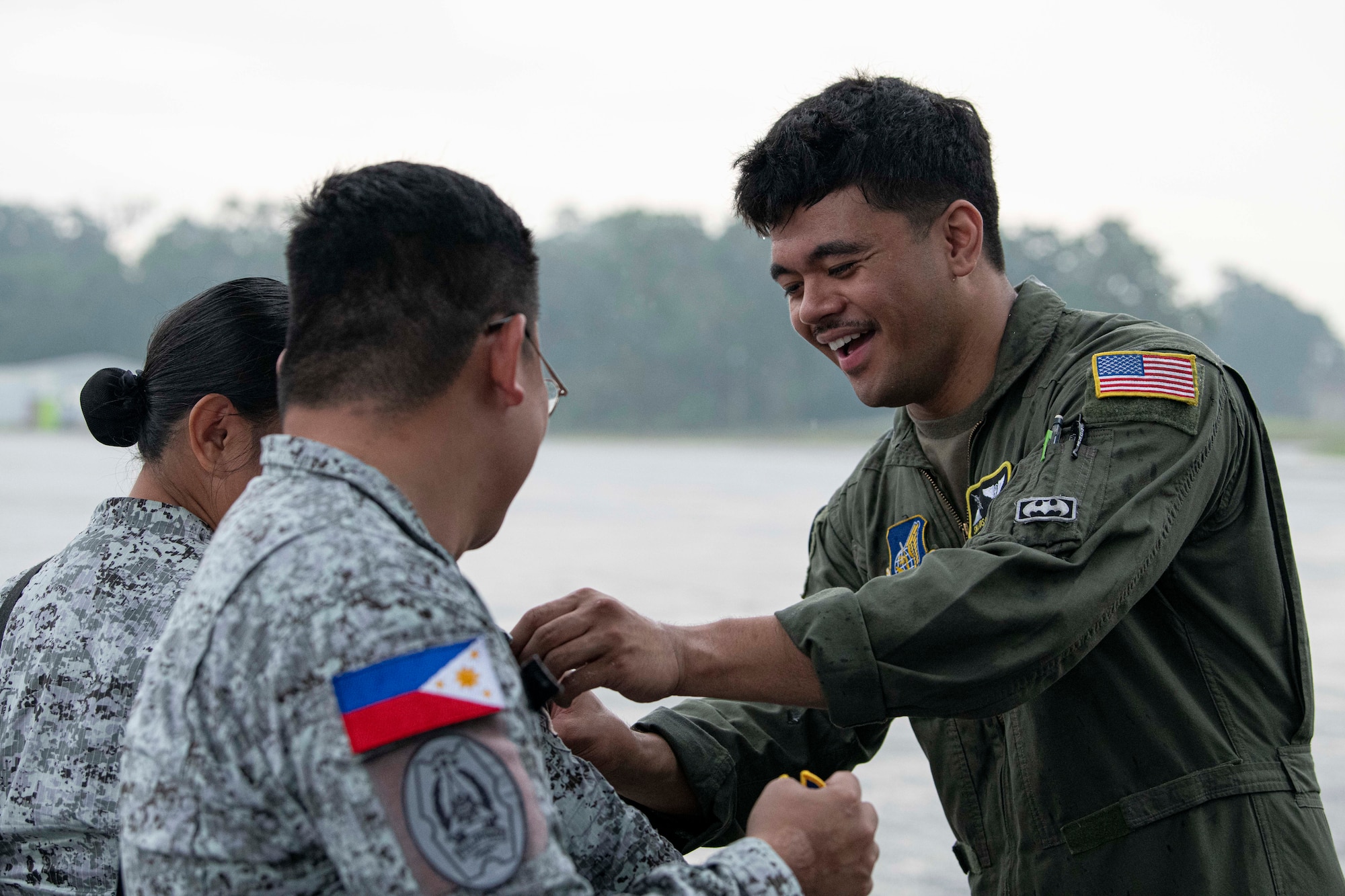 An Airman exchanges patches with members of the Philippine Air Force during a foreign disaster relief operation.
