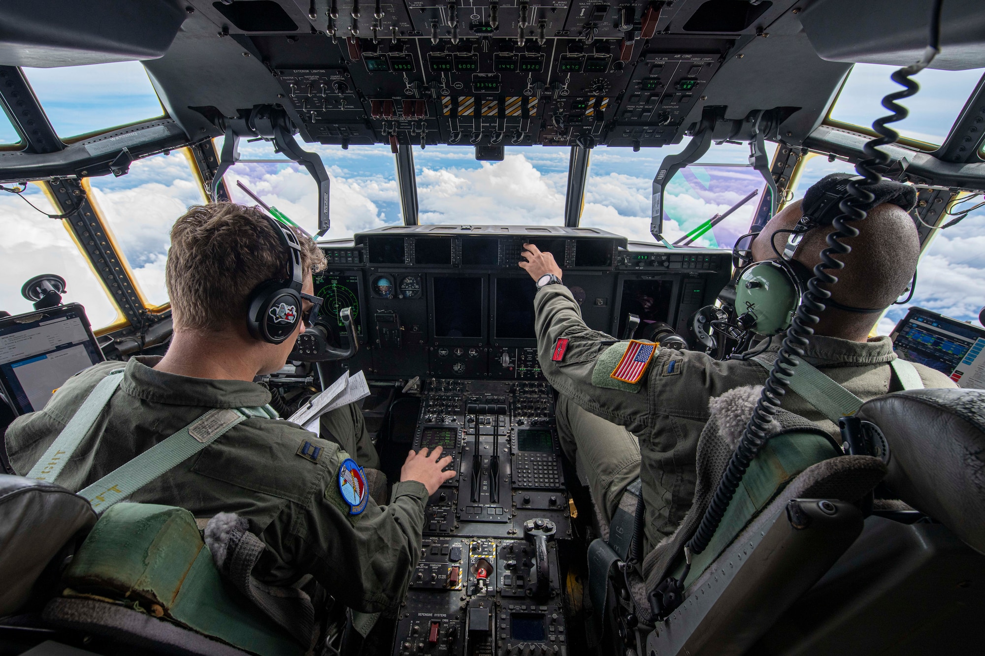 Airmen fly a C-130J Super Hercules over Philippine airspace to deliver family food packs during a foreign disaster relief operation.