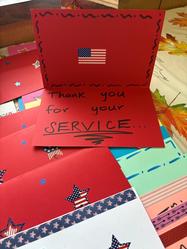 Red card opened with the words "Thank you for your service" written inside