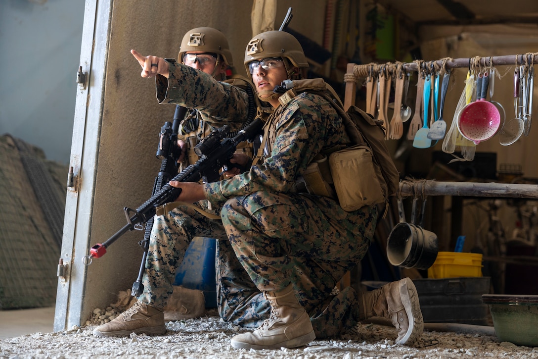 U.S. Marines with Combat Logistics Battalion 2, Combat Logistics Regiment 2, 2nd Marine Logistics Group, prepare for a mock fight at the Infantry Immersion Trainer at Marine Corps Base Camp Lejeune, North Carolina, Nov. 21, 2025. The IIT is a facility which provides an urban training environment for Marines and Sailors, aiding in increasing combat efficiency by training in realistic conditions. (U.S. Marine Corps photo by Lance Cpl. Isabella Ramos)