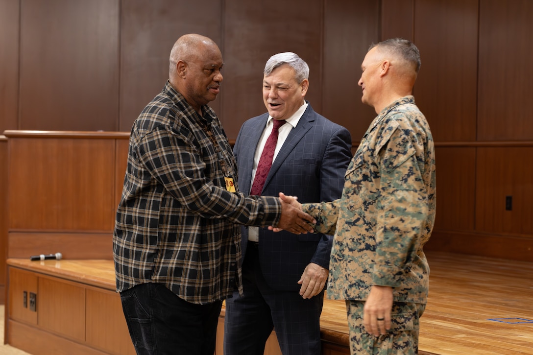 U.S. Marine Corps Lt. Gen. Leonard F. Anderson IV (right) and Mr. Gregg Habel (center) commander and executive director, respectively, of Marine Forces Reserve and Marine Forces South, recognizes Olin Lott’s 45 years of federal service during a town hall meeting at Marine Corps Support Facility New Orleans, Nov. 20, 2025. Lott currently serves with Marine Forces Reserve Installation Personnel Administration Center. (U.S. Marine Corps photo by Lance Cpl. Carlina Holland)
