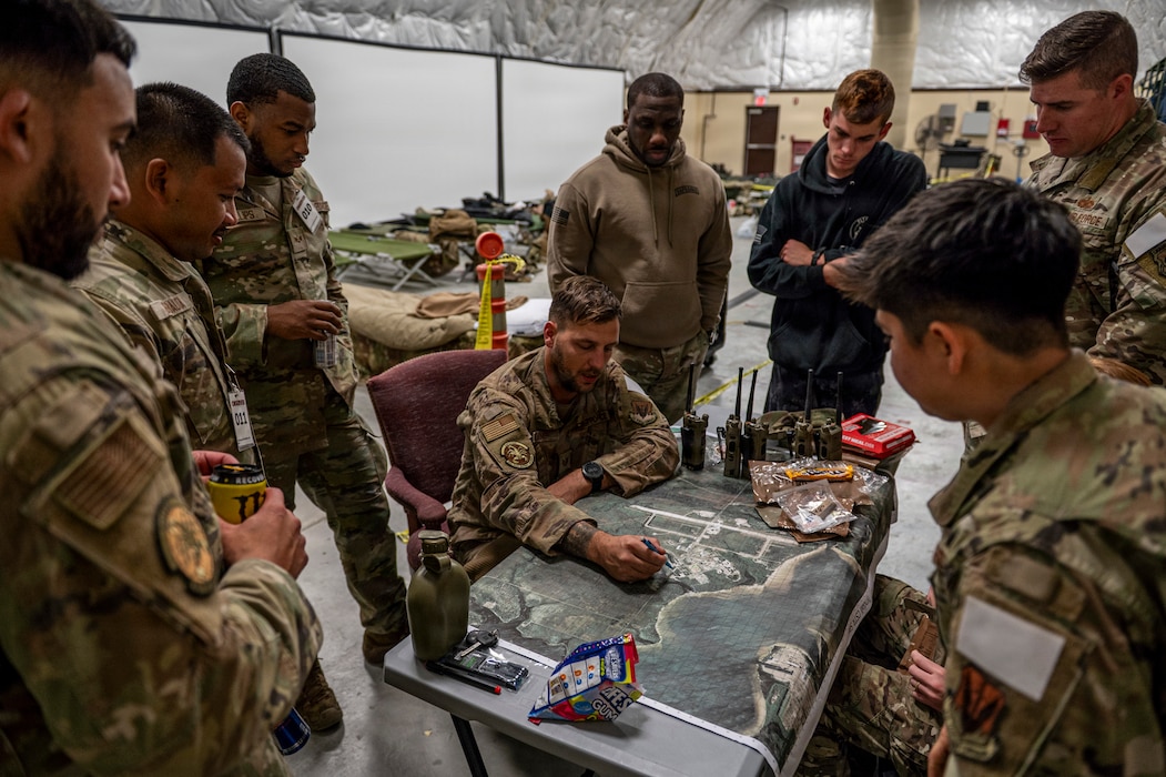 U.S. Air Force Airmen assigned to the 822nd Base Defense Squadron plan a mission during Exercise MOSAIC TIGER 26-1 at Tyndall Air Force Base, Georgia, Nov. 18, 2025. Acting as a simulated enemy, the team challenged Flying Tigers to identify, track and counter hostile activity across dispersed locations. (U.S. Air Force photo by Senior Airman Leonid Soubbotine)