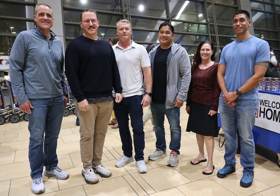 SAN DIEGO (Oct. 16, 2025) – From left, Rear Adm. Kevin Brown, commander, Naval Medical Forces Pacific (NMFP), Capt. Jonas Carmichael, officer-in-charge, Navy Expeditionary Medical Unit 10 Gulf (EMU-10G), Master Chief Hospital Corpsman Chad McFall, EMU 10G senior enlisted leader, Command Master Chief Jerry Cantorna, NMFP, Capt. Elizabeth Adriano, commanding officer, Navy Medicine Readiness and Training Command (NMRTC) San Diego, and NMRTC San Diego’s Command Master Chief Adolfo Gonzalez pose for a group photo at San Diego International Airport. EMU-10G returned from a seven-month deployment in the Middle East supporting Operation Inherent Resolve. (U.S. Navy photo by Arsenio R. Cortez Jr.)
