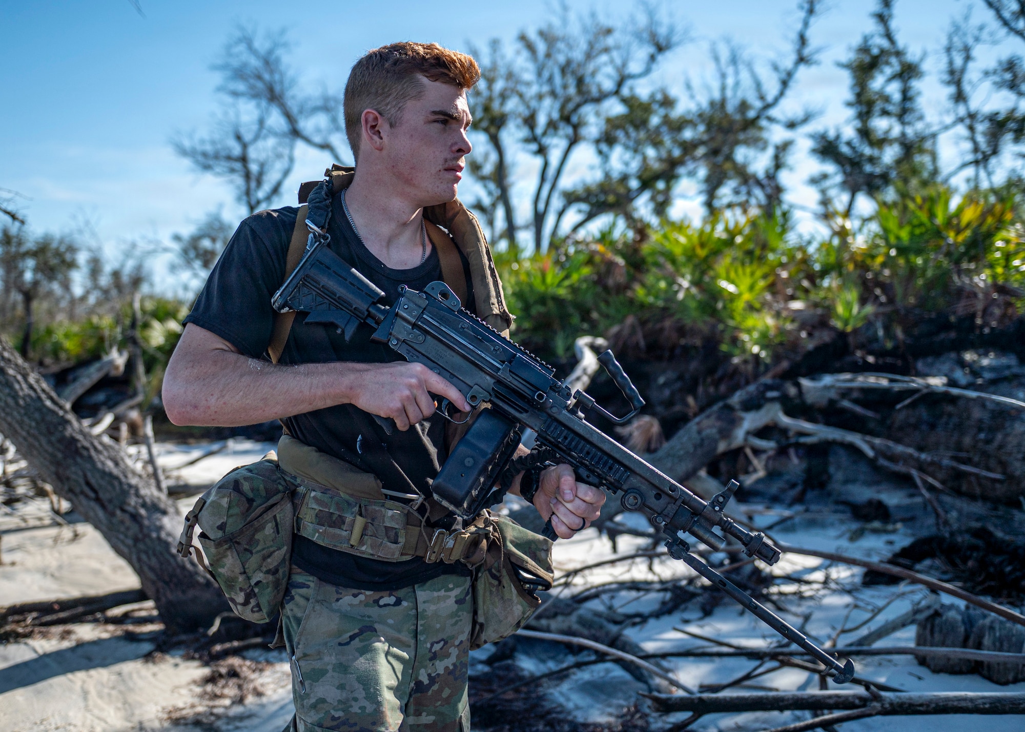 U.S. Air Force Airman 1st Class Nicholas Rich, 822nd Base Defense Squadron fire team member, patrols during Exercise MOSAIC TIGER 26-1 at Tyndall Air Force Base, Georgia, Nov. 19, 2025. Serving as the opposing force, 822d BDS Airmen created realistic threats that helped Moody Airmen practice identifying and responding to enemy activity. (U.S. Air Force photo by Senior Airman Leonid Soubbotine)