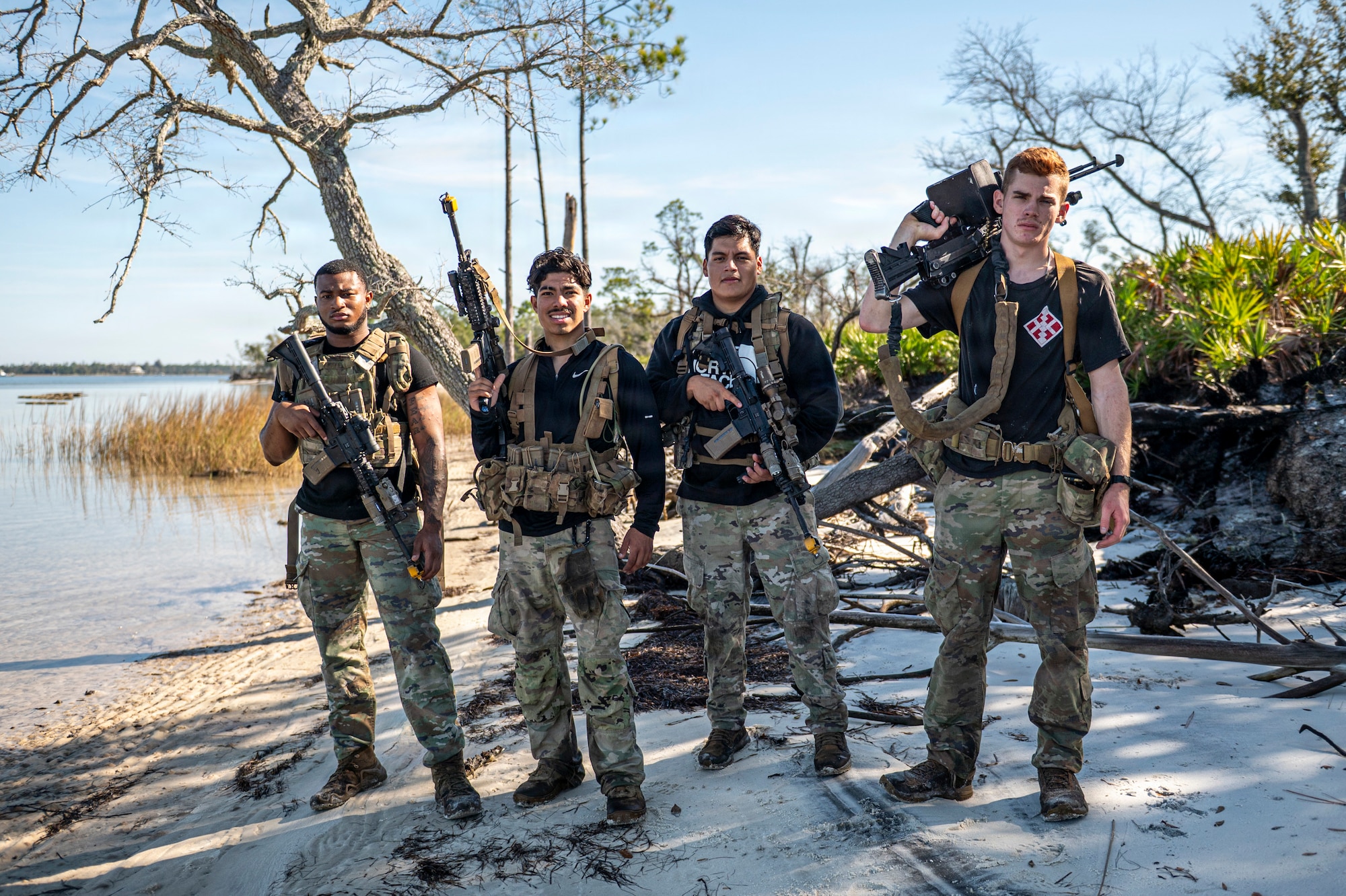 U.S. Air Force Airmen assigned to the 822nd Base Defense Squadron pose during Exercise MOSAIC TIGER 26-1 at Tyndall Air Force Base, Georgia, Nov. 19, 2025. The team performed simulated opposing force reconnaissance and attacks to test the 23d Wing response to unknown threats in austere locations. (U.S. Air Force photo by Senior Airman Leonid Soubbotine)
