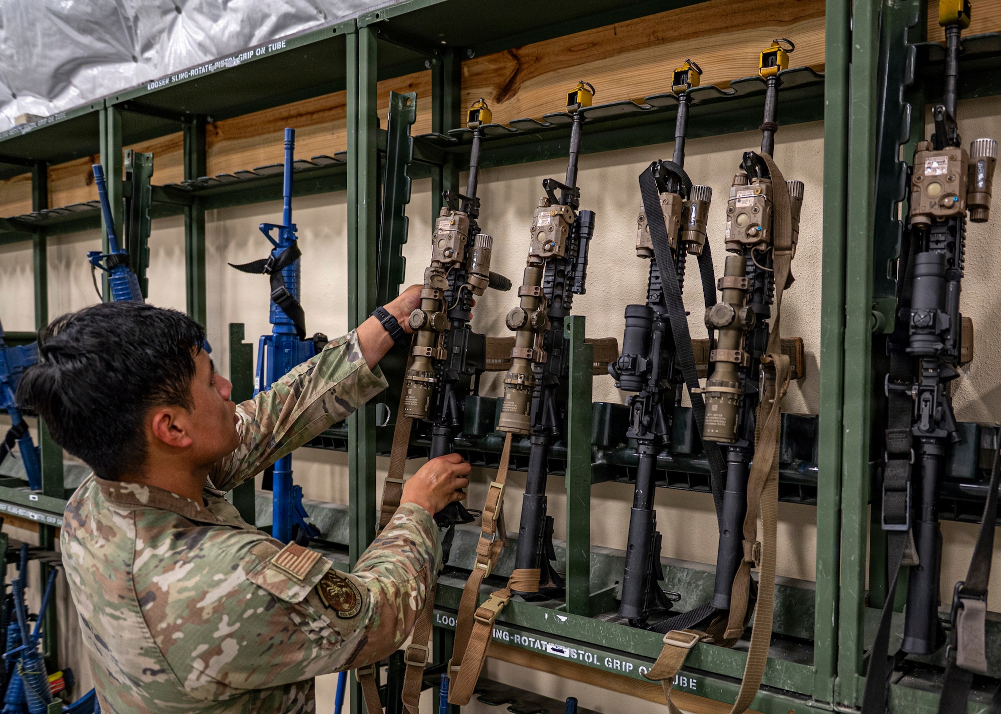 U.S. Air Force Senior Airman Marlon Yunga, 822nd Base Defense Squadron fire team member, picks up a rifle during Exercise MOSAIC TIGER 26-1 at Tyndall Air Force Base, Georgia, Nov. 19, 2025. Yunga and his team acted as aggressors throughout the scenario, testing participants’ ability to respond to unexpected enemy activity. (U.S. Air Force photo by Senior Airman Leonid Soubbotine)