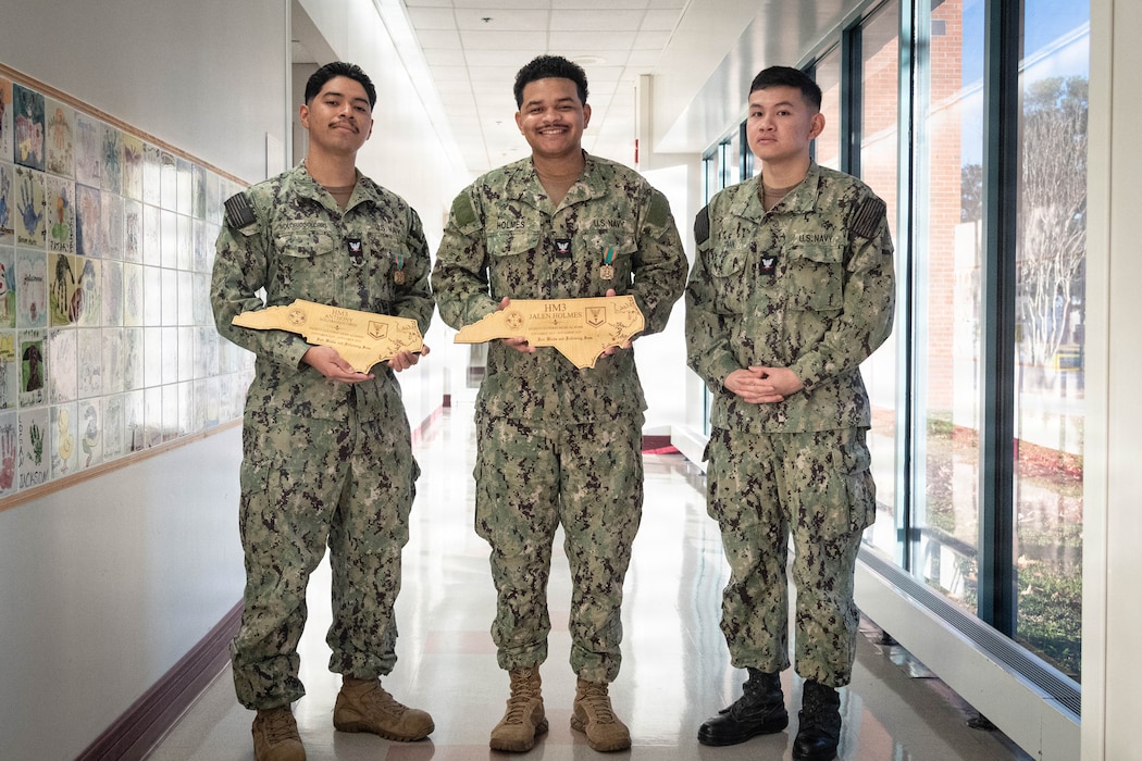 The staff of Naval Health Clinic Cherry Point gathered Monday, November 24 to celebrate the promotion of one Corpsman and honor the excellence in patient care of two others.

Hospital Corpsman Third Class An Tran, right, promoted to the rank.  Tran serves in the clinic’s Preventive Medicine Department.

Hospital Corpsman Third Class Jalen Holmes, center, was awarded the Navy and Marine Corps Achievement Medal for his service in the clinic’s Patient Centered Medical Home from November 2023 to December 2025.

Hospital Corpsman Third Class Anthony Soloriosolorio, left, was awarded the Navy and Marine Corps Acheivement Medal for his service in the clinic’s Patient Centered Medical Home from October 2023 to November 2025.

Soloriosolorio was also awarded the Military Outstanding Volunteer Service Medal for contributing 223 volunteer hours to various organizations like the Armed Services Blood Program, Seashore Soccer League and MCAS Cherry Point Food Drive.