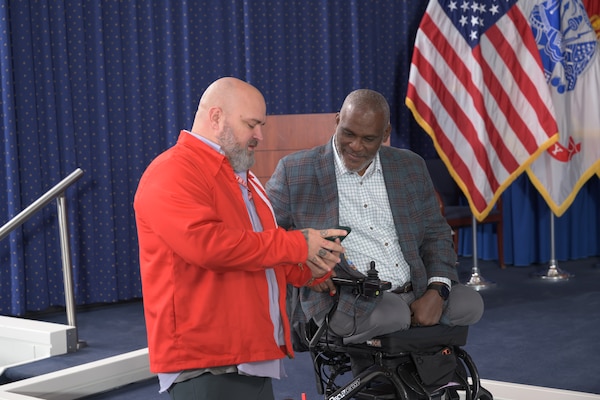 Jeff Waldron, left, from DLA Human Capital Transformation, and retired Army Col. Gregory Gadson, right, former Fort Belvoir garrison commander, speak after Gadson's Warfighter Talk at Fort Belvoir, Virginia, Oct. 22, 2025. Waldon's son is an amputee and was inspired by Gadson's role in "Battleship." (DOD photo by Chris Lynch)