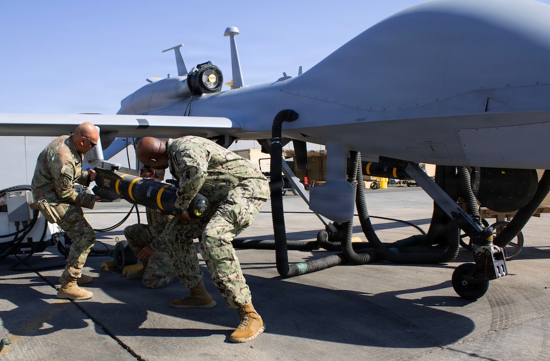 U.S. Navy Fleet Master Chief Lateef Compton, senior enlisted leader of U.S. Central Command, and U.S. Army Command Sgt. Maj. Arnold Reyes, senior enlisted leader of Operation Spartan Shield, load an unmanned aerial vehicle (UAV) in Southeastern Syria, Nov. 8, 2025. UAV’s are used to strike targets in support of Combined Joint Task Force - Operation Inherent Resolve’s mission to ensure the continued military defeat of ISIS.  (British Army photo by Maj. Miles Cuff)