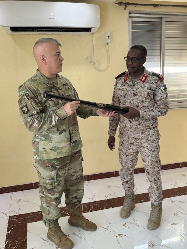 U.S. Army Lt. Col. Daniel Cooper presents a Louisville Slugger baseball bat to a member of the Djiboutian Armed Forces, August 2025.