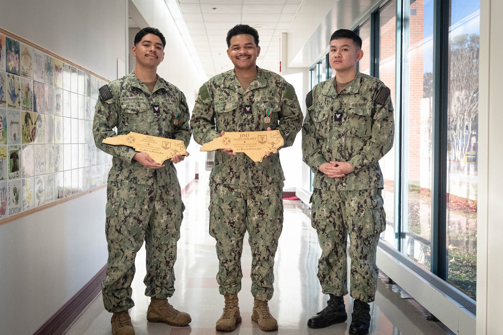 The staff of Naval Health Clinic Cherry Point gathered Monday, November 24 to celebrate the promotion of one Corpsman and honor the excellence in patient care of two others.

Hospital Corpsman Third Class An Tran, right, promoted to the rank.  Tran serves in the clinic’s Preventive Medicine Department.

Hospital Corpsman Third Class Jalen Holmes, center, was awarded the Navy and Marine Corps Achievement Medal for his service in the clinic’s Patient Centered Medical Home from November 2023 to December 2025.

Hospital Corpsman Third Class Anthony Soloriosolorio, left, was awarded the Navy and Marine Corps Acheivement Medal for his service in the clinic’s Patient Centered Medical Home from October 2023 to November 2025.

Soloriosolorio was also awarded the Military Outstanding 
Volunteer Service Medal for contributing 223 volunteer hours to various organizations like the Armed Services Blood Program, Seashore Soccer League and MCAS Cherry Point Food Drive.