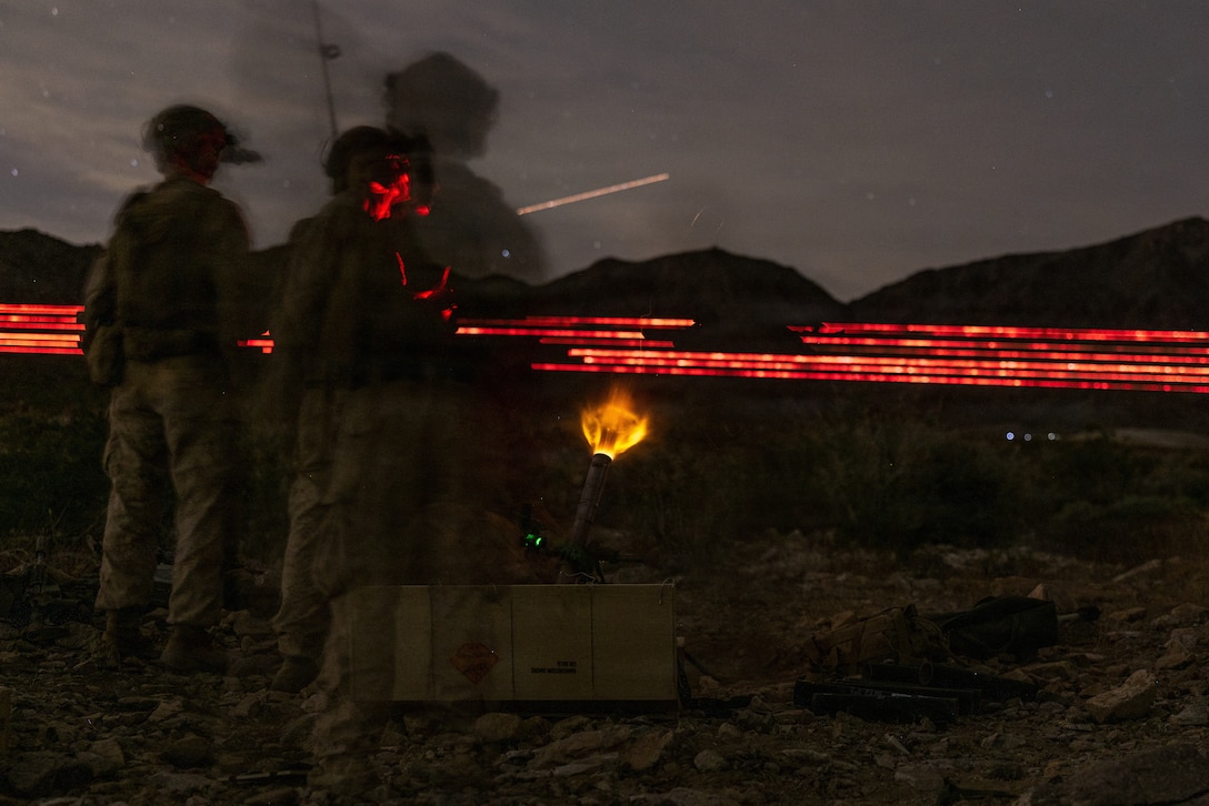 U.S. Marines with Weapons Company, 3rd Battalion, 7th Marine Regiment, 1st Marine Division, fire an M224 60 mm mortar system during Range 400 at Marine Corps Air-Ground Combat Center Twentynine Palms, California, Oct. 25, 2025. Range 400 is a dynamic live-fire range that allows companies the ability to rehearse tactics and procedures for attacking fortified areas. (U.S. Marine Corps photo by Cpl. Earik Barton)