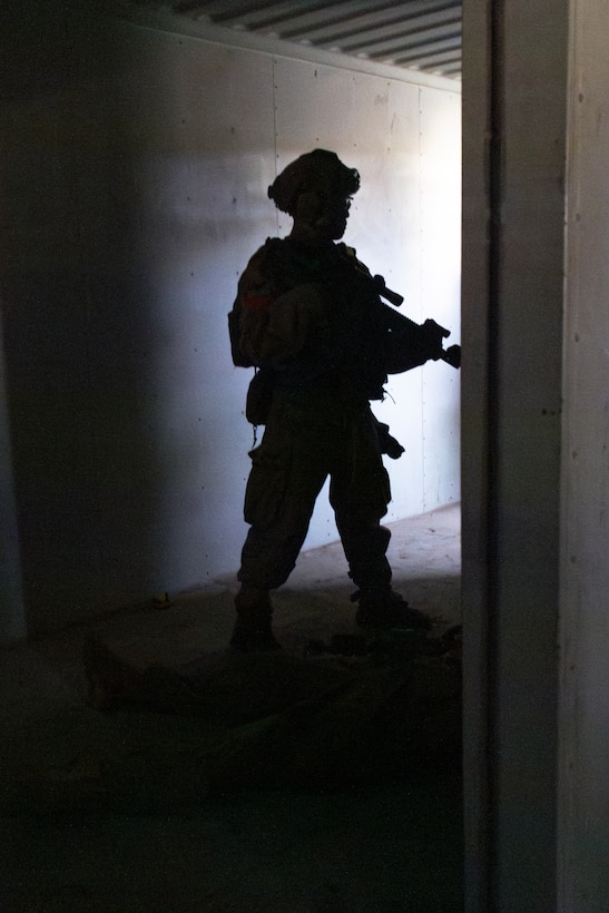 A U.S. Marine with 1st Battalion, 1st Marine Regiment, 1st Marine Division, prepares to conduct close-quarters battle drills during a vertical assault course at Marine Corps Base Camp Pendleton, California, Nov. 19, 2025.
