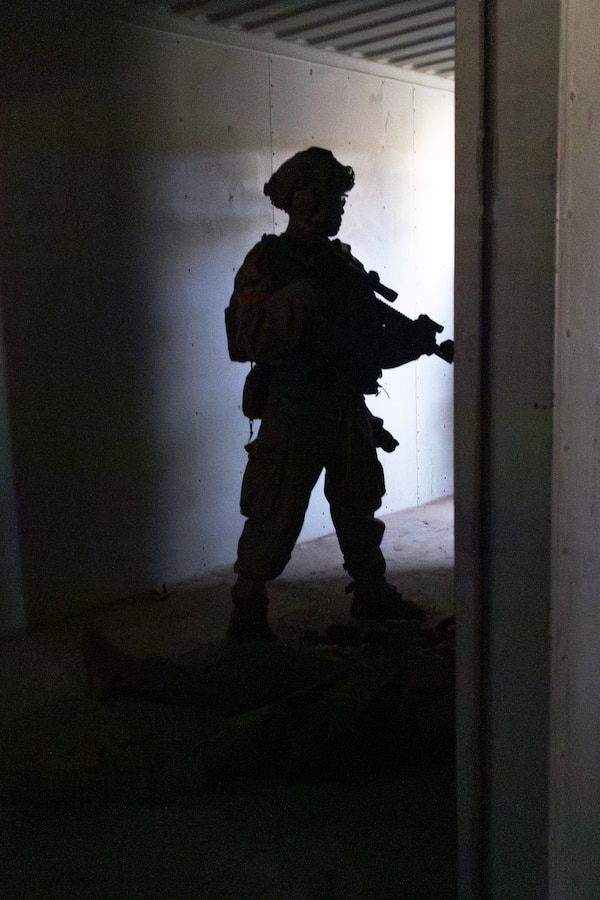 A U.S. Marine with 1st Battalion, 1st Marine Regiment, 1st Marine Division, prepares to conduct close-quarters battle drills during a vertical assault course at Marine Corps Base Camp Pendleton, California, Nov. 19, 2025. Expeditionary Operations Training Group, I Marine Expeditionary Force, conducts vertical assault and raid training to develop advanced tactical skills and maintain readiness for future deployments. (U.S. Marine Corps photo by Cpl. Mary R. Jenni)