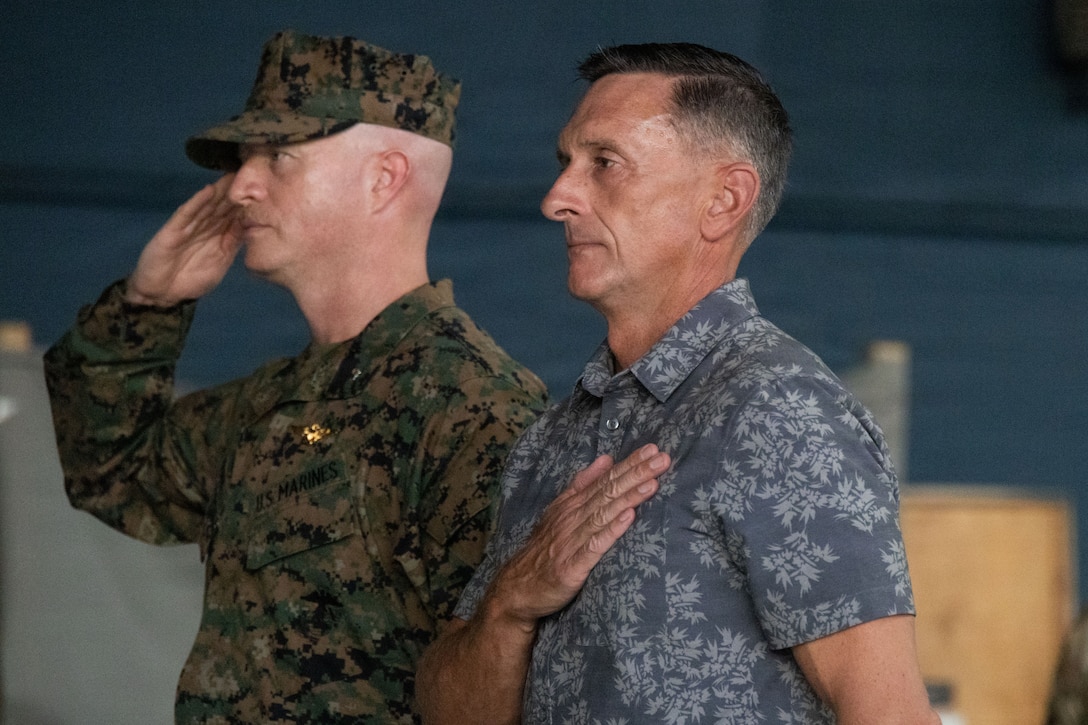 The commanding officer of Marine Fighter Attack Squadron (VMFA) 225, U.S. Marine Corps Forces, South, and U.S. Marine Corps. Col. Chad Vaughn (Ret.), former commanding officer of Marine Aircraft Group 13, 3rd Marine Aircraft Wing, salute the colors while the national anthem is played at Jose Aponte de la Torre Airport in Ceiba, Puerto Rico, Nov. 14, 2025. U.S. military forces are deployed to the Caribbean in support of the U.S. Southern Command mission, Department of War-directed operations, and the president’s priorities to disrupt illicit drug trafficking and protect the homeland. (U.S. Marine Corps photo)